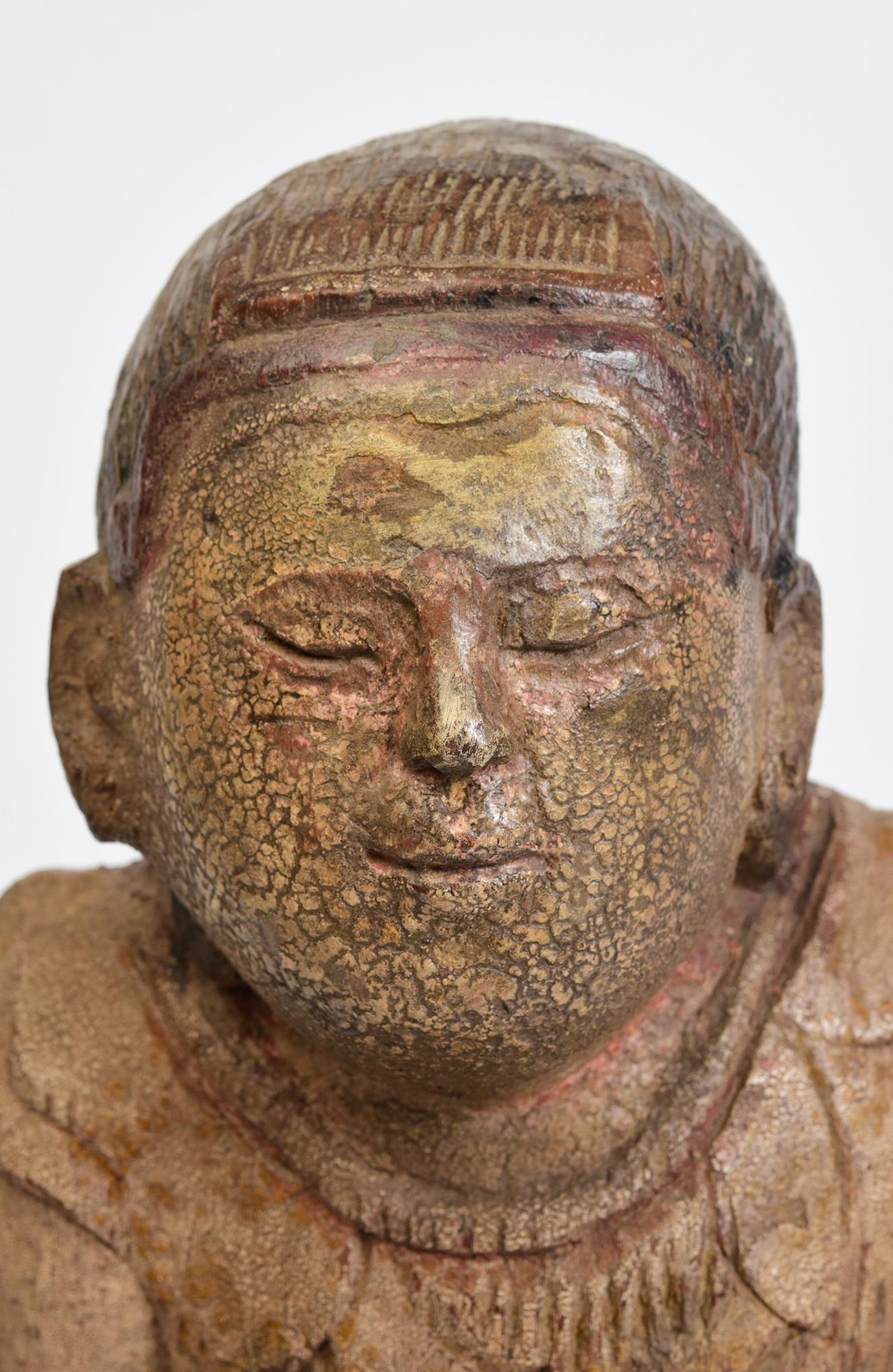 Antique Burmese wooden seated figure.

Age: Burma, Mandalay Period, 19th Century
Size: Height 34.3 C.M. / Width 17 C.M. / Depth 15.5 C.M.
Condition: Nice condition overall (some expected degradation due to its age). 

100% Satisfaction and