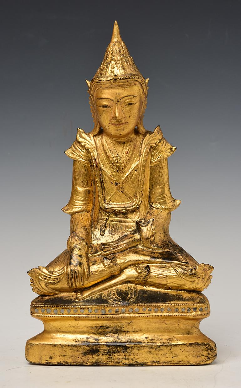 Antique Burmese wooden seated crowned Buddha with gilded gold or sometimes known as 'King Buddha's, wearing diadem-crowns and ornaments of kings instead of ordinary monk's robes. 

Age: Burma, Mandalay Period, 19th century
Size: Height 31.8 C.M. /