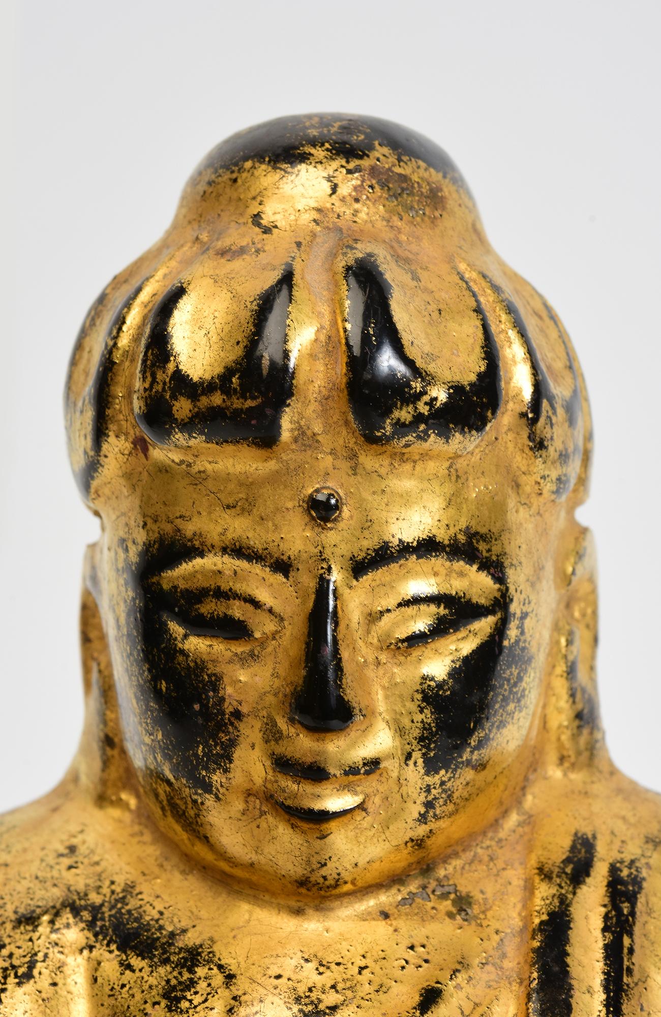 Antiker burmesischer Lotus-Buddha aus Holz, sitzend in der Mara-Vijaya-Haltung (die Erde zum Zeugen rufend), auf einem Sockel, mit vergoldetem Gold.

Alter: Birma, Mandalay-Periode, 19. Jahrhundert
Größe: Höhe 25 C.M. / Breite 13.6 C.M. / Tiefe 13.8