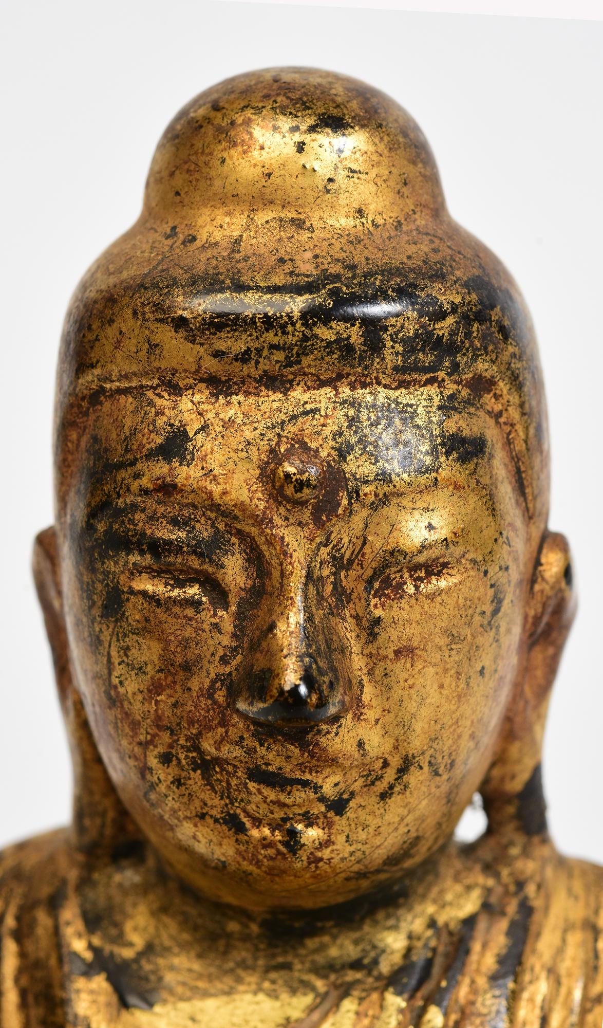 Antique Burmese wooden lotus Buddha sitting in Mara Vijaya (calling the earth to witness) posture on a base, with gilded gold.

Age: Burma, Mandalay Period, 19th Century
Size: Height 13 C.M. / Width 8.6 C.M. / Depth 4.2 C.M.
Condition: Nice