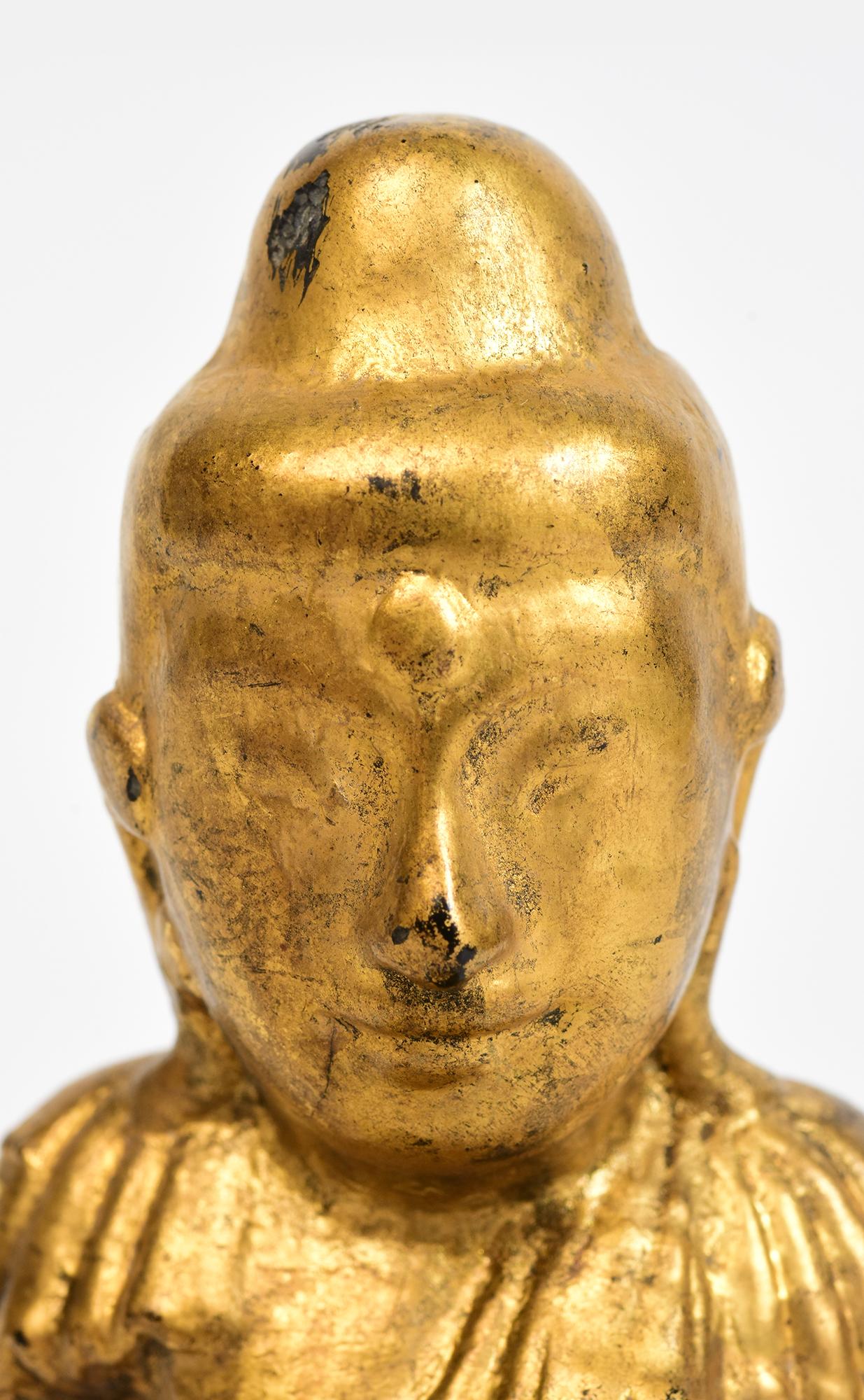 Burmese wooden lotus Buddha sitting in Mara Vijaya (calling the earth to witness) posture on a base with gilded gold.

Age: Burma, Mandalay Period, 19th Century
Size: Height 13 C.M. / Width 8 C.M. / Depth 4.5 C.M.
Condition: Nice condition overall
