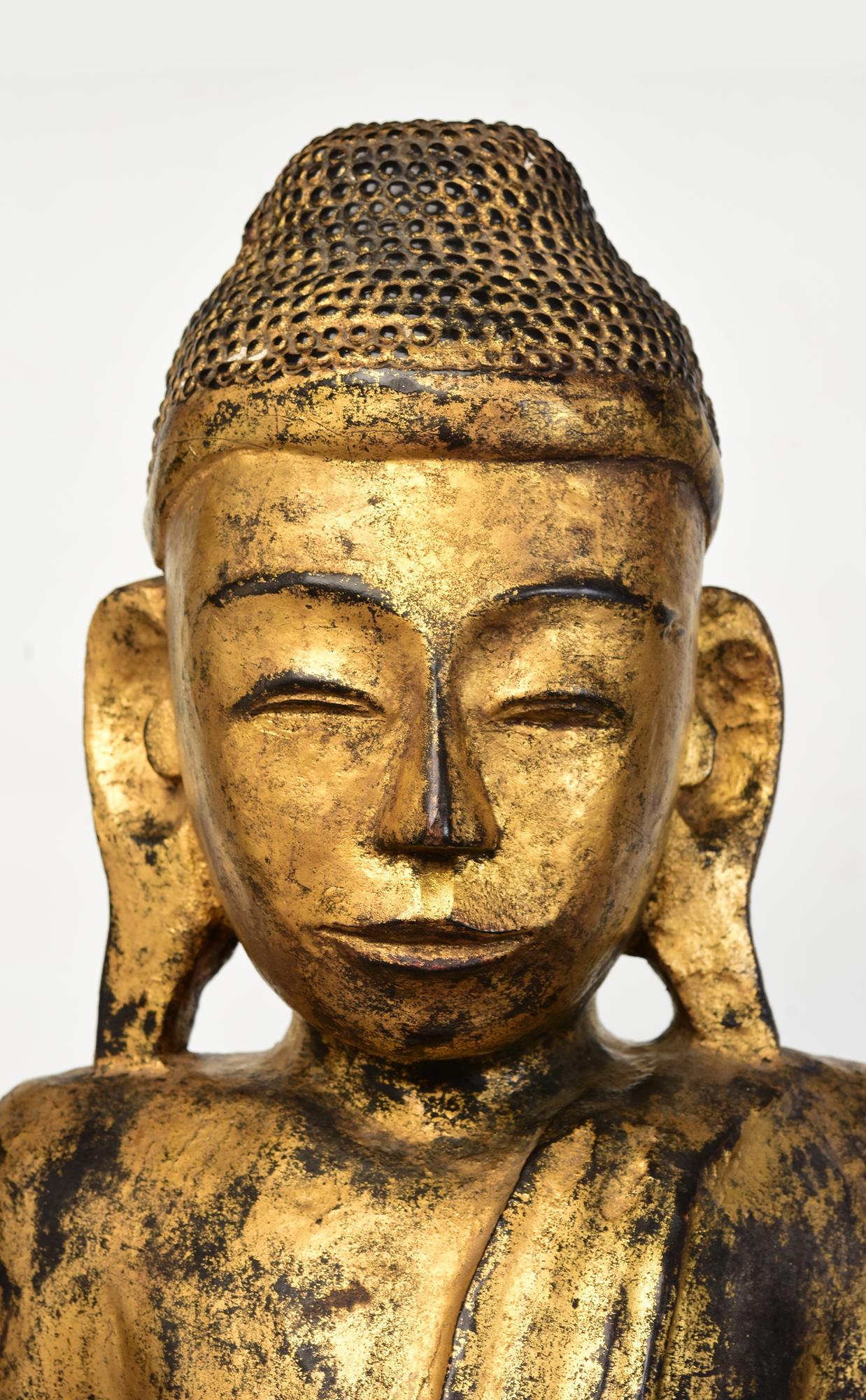 Antique Burmese wooden standing Buddha on a base with gilded gold.

Age: Burma, Mandalay Period, 19th Century
Size excluding black stand: Height 82.6 C.M. / Width 30.5 C.M. / Depth 16.2 C.M.
Height including black stand: 99.8 C.M.
Condition: Nice