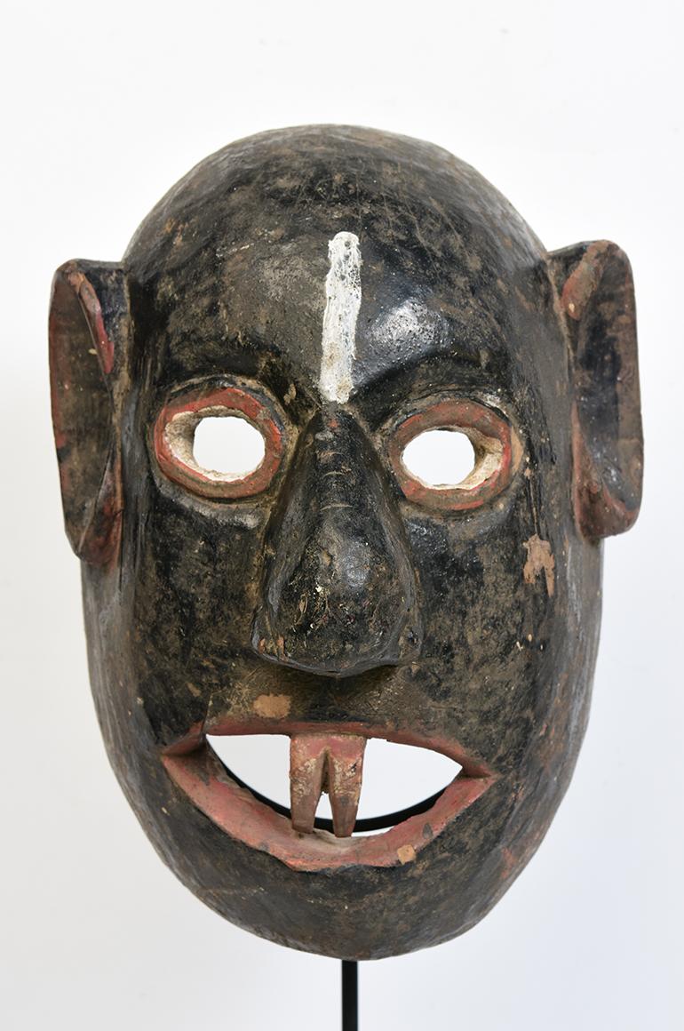 Burmese wooden tribal mask.

Age: Burma, Mandalay Period, 19th century
Size: Height 27 C.M. / Width 20 C.M. / Thickness 17.3 C.M.
Size including stand: Height 58.5 C.M.
Condition: Nice condition overall (some expected degradation due to its