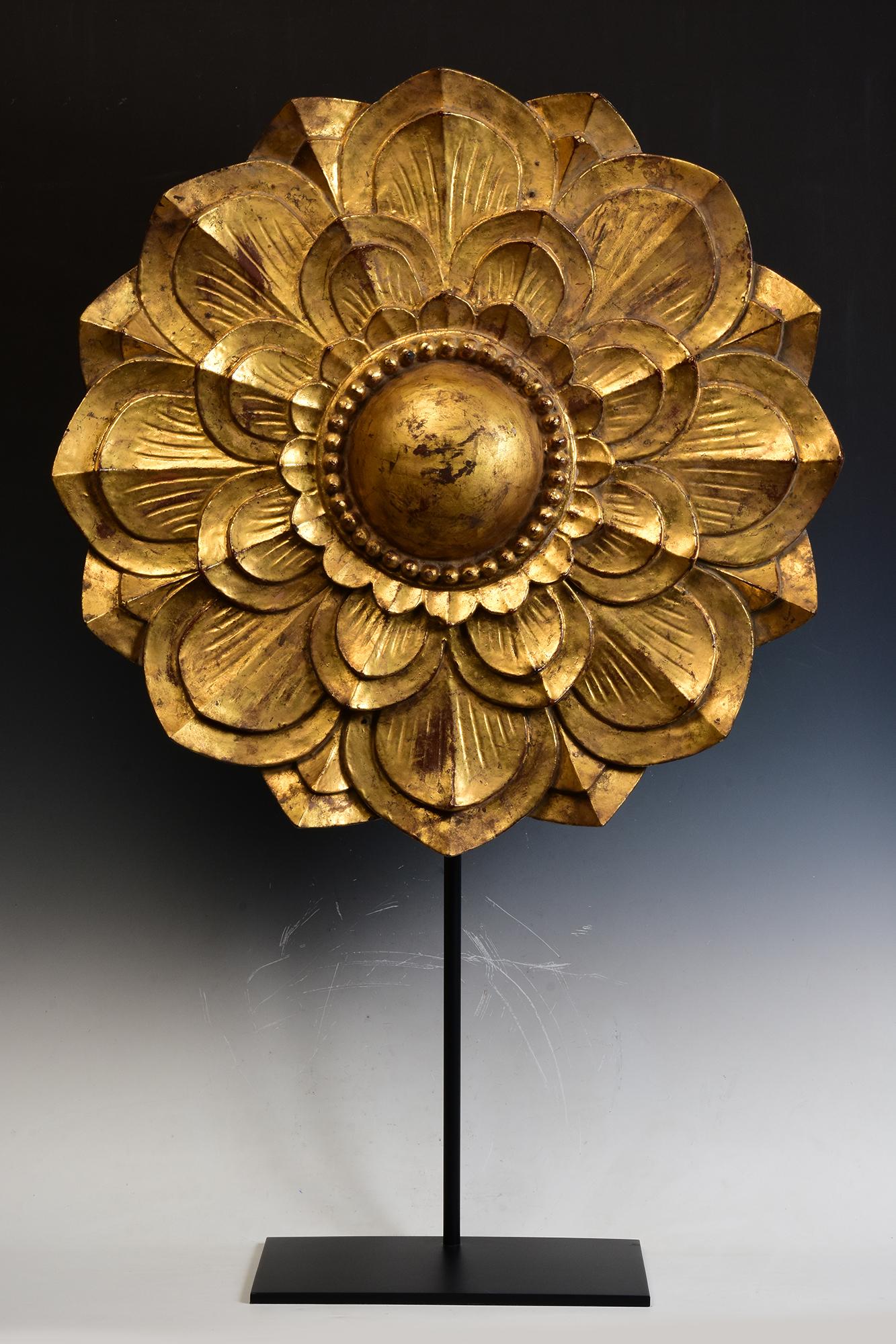 Large Burmese wooden flower decoration with gilded gold.

Age: Burma, Mandalay Period, 19th Century
Size of flower only: Diameter 69.5 C.M. / Thickness 10 C.M.
Height including stand: 108 C.M.
Condition: Nice condition overall (some expected