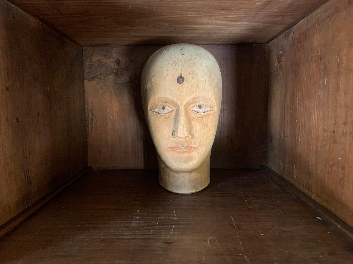 A 19th century French mannekin head in beech with original polychrome remains.