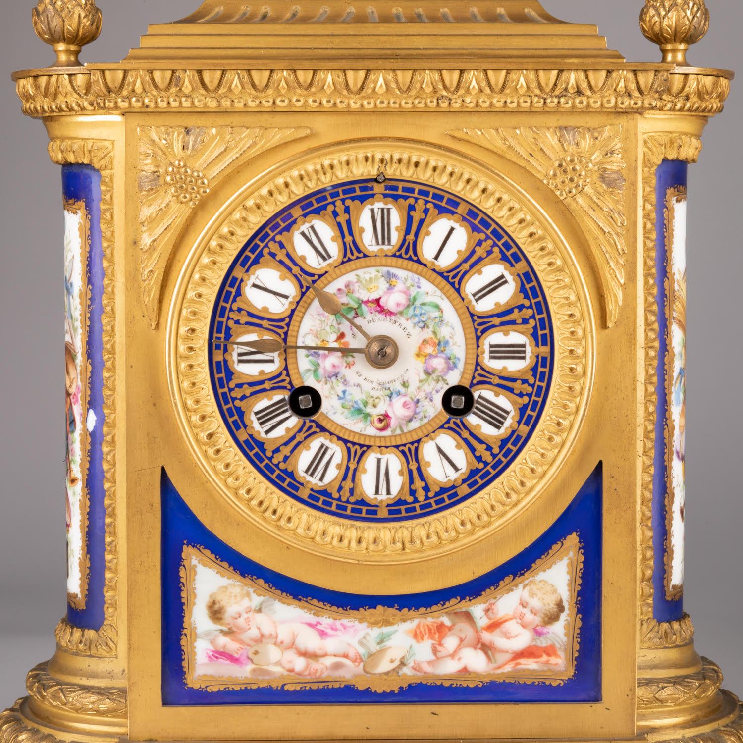 19th century mantel set by Delettrez, Napoleon III period.

Gilt bronze and painted porcelain mantel set, porcelain dial, 19th century, Napoleon III period by Delettrez, simple overhaul of the movement required.    
Clock: h: 37cm, w: 26cm, d: