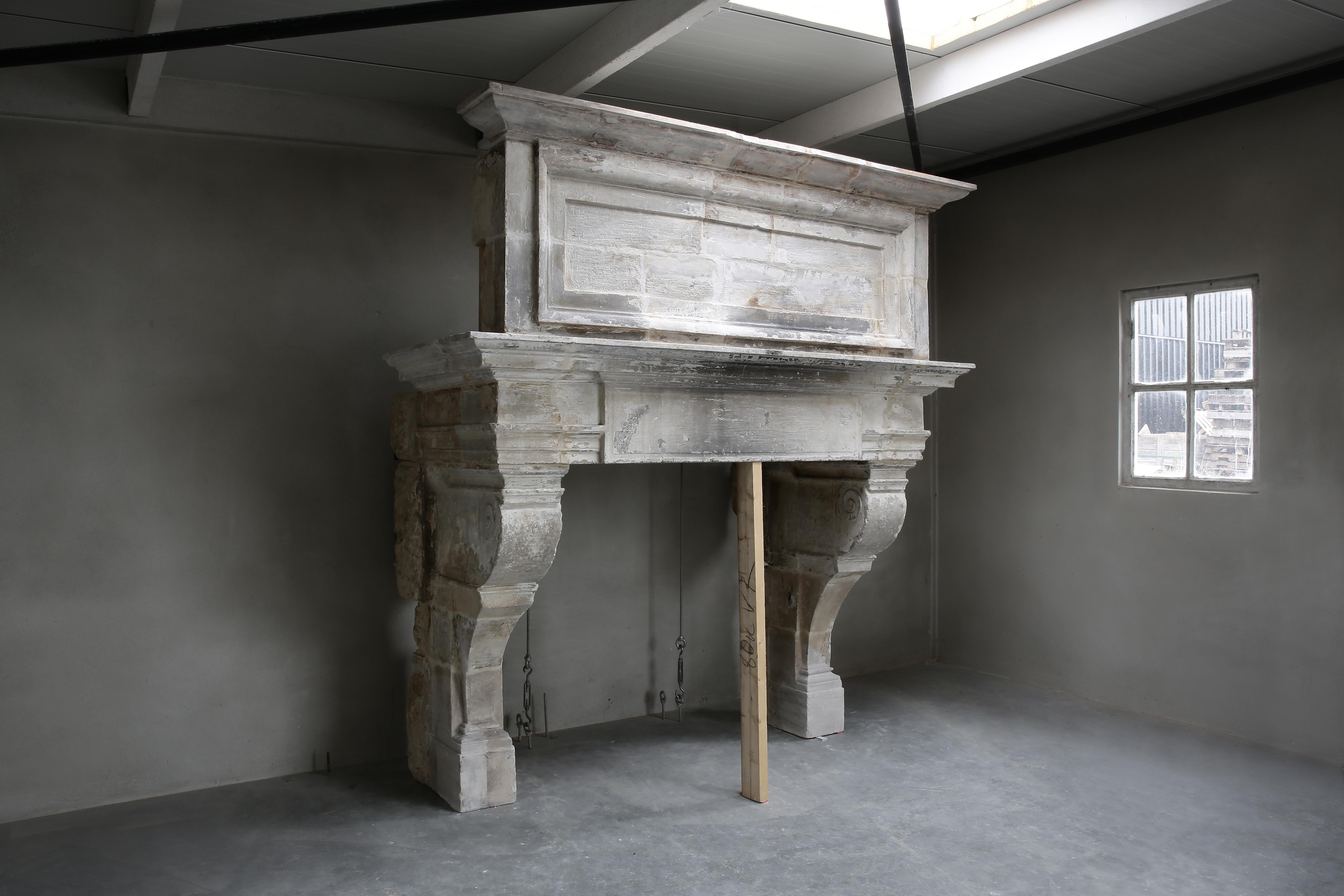 A beautiful castle fireplace of French limestone with Trumeau. This fireplace dates from the 19th century and is in the style of Louis XIII. A robust mantel (fireplace) with beautiful lines and a stately appearance! The Trumeau on top of the