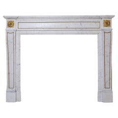 Antique 19th Century Mantelpiece of white Carrara marble with fire-gilded decorations