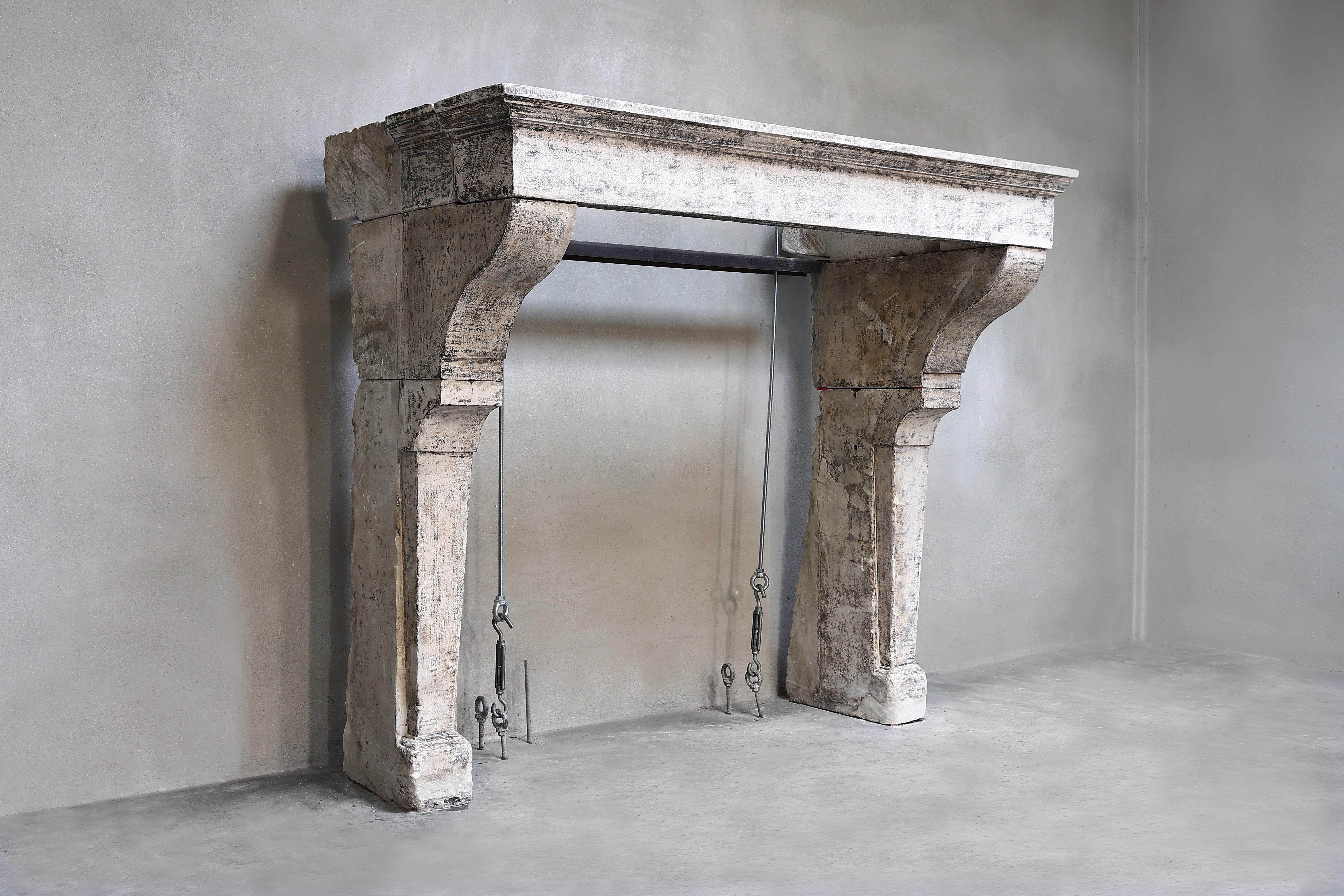 Beautiful rustic fireplace of French limestone from the 19th century. This antique fireplace is rustic and has beautiful lines. The natural color scheme ensures that this fireplace in Campagnarde style can be used for many interiors.