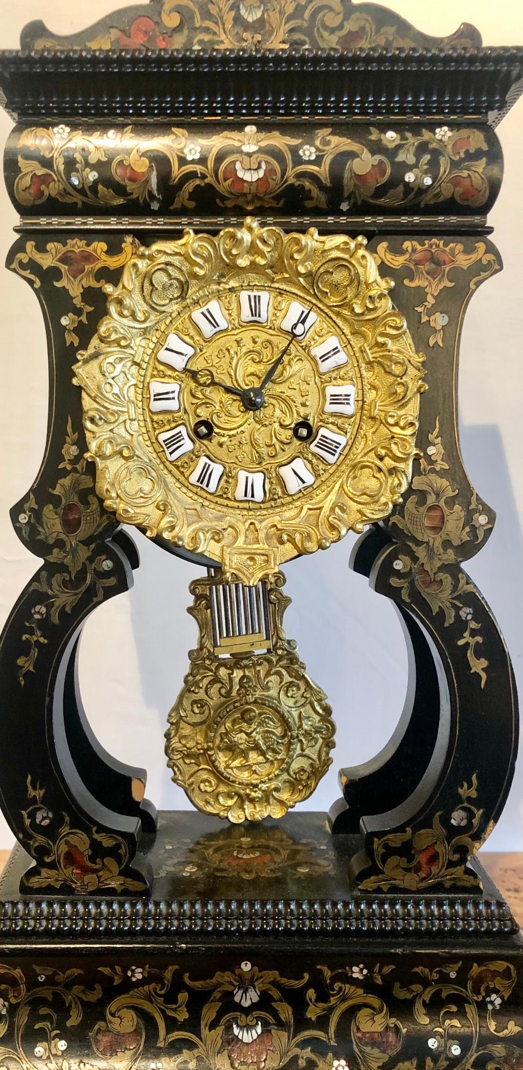 19th century mantle clock Louis Philippe ebony and boule inlaid. The fine and very decorative mantle clock has ornate bronze work with a bronze pendulum. Not working at this time.
ZZL.