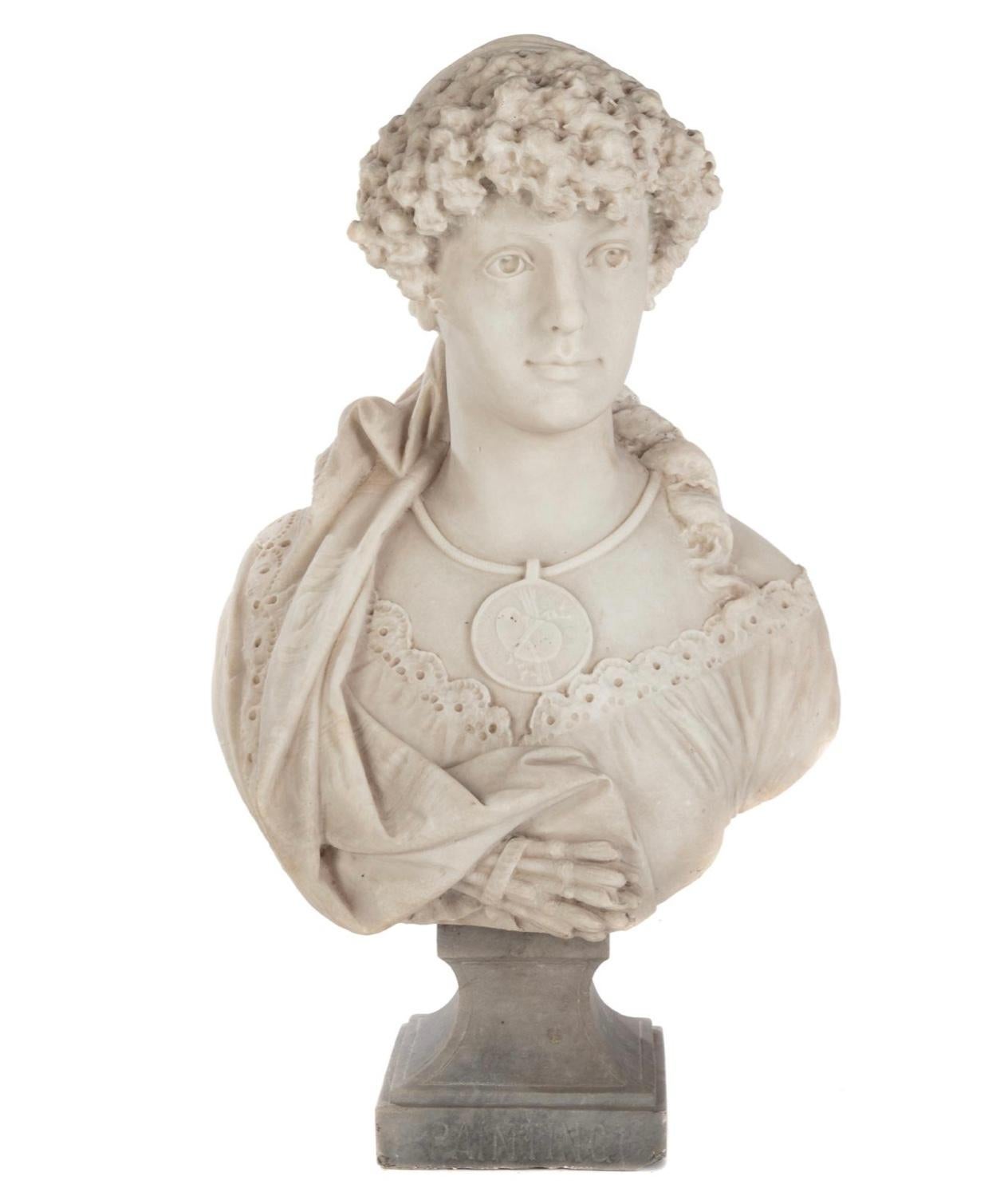 Finely sculpted late 19th century white marble bust, modeled as a young maiden in a lacey frock, carved wearing a necklace suspended from her neck with a circular pendant carved as an artist palette. A series of brushes carved below her breast,