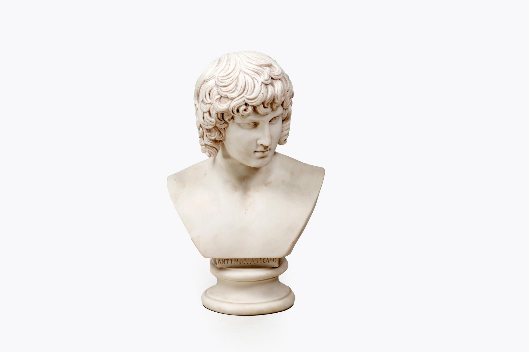 19th Century Marble Bust of Antinous after the original known as the 'Antinous Vaticano' discovered at Hadrian's Villa. Featuring realistic detail to hair and handsome facial features. With inscription ‘Antino Vaticano’ to base.