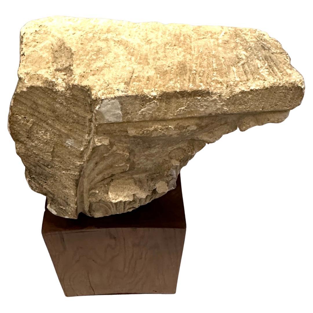 Hand-carved marble capital fragment mounted on a wooden base.  Base: 9.5