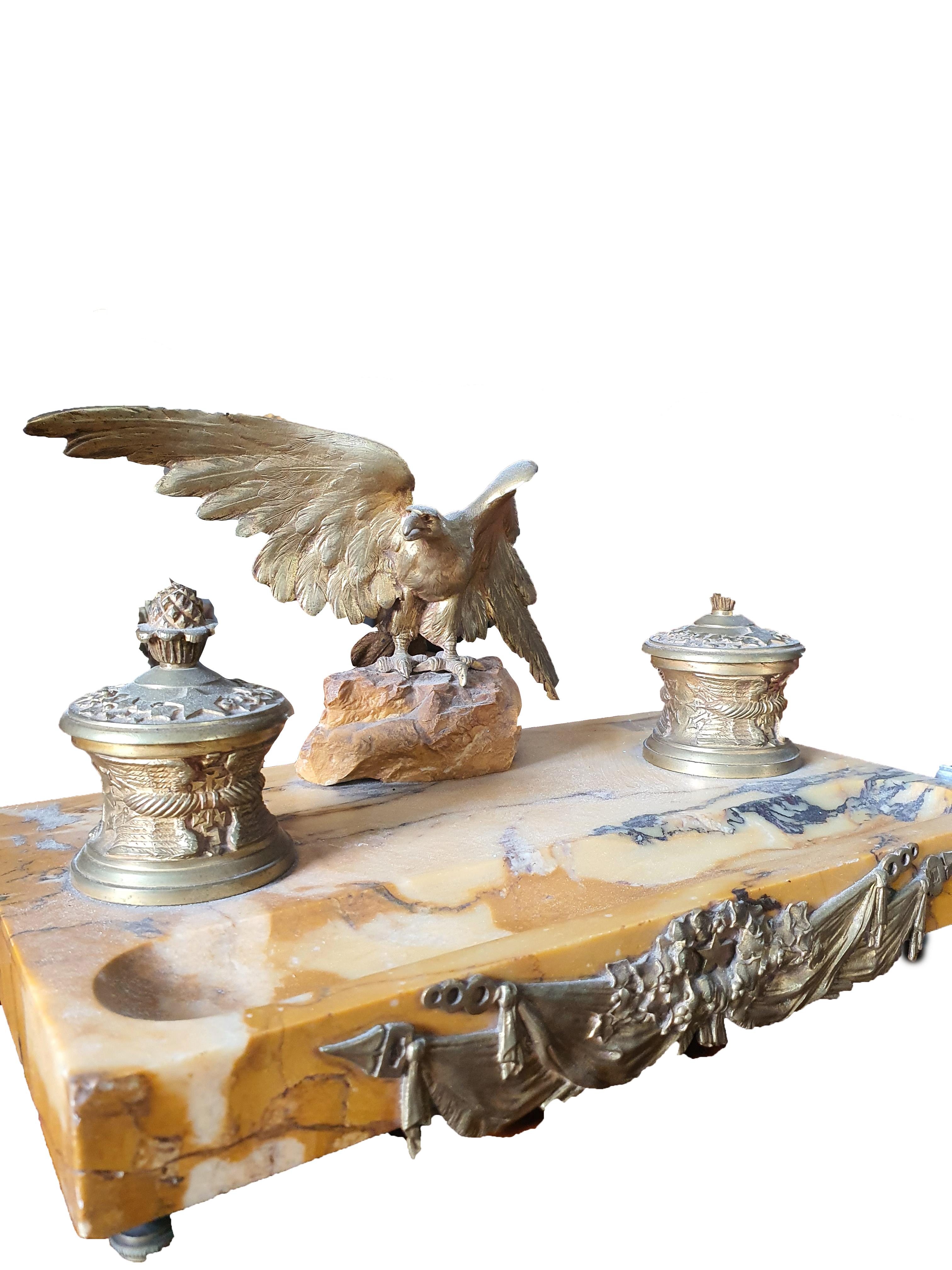Elegant inkwell made of antique yellow marble, with applications and central eagle in finely chiseled and gilded bronze.
