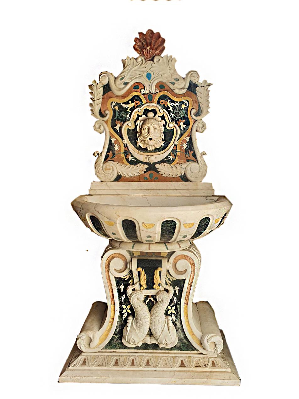 Elegant marble wall fountain, entirely inlaid with various precious marbles.