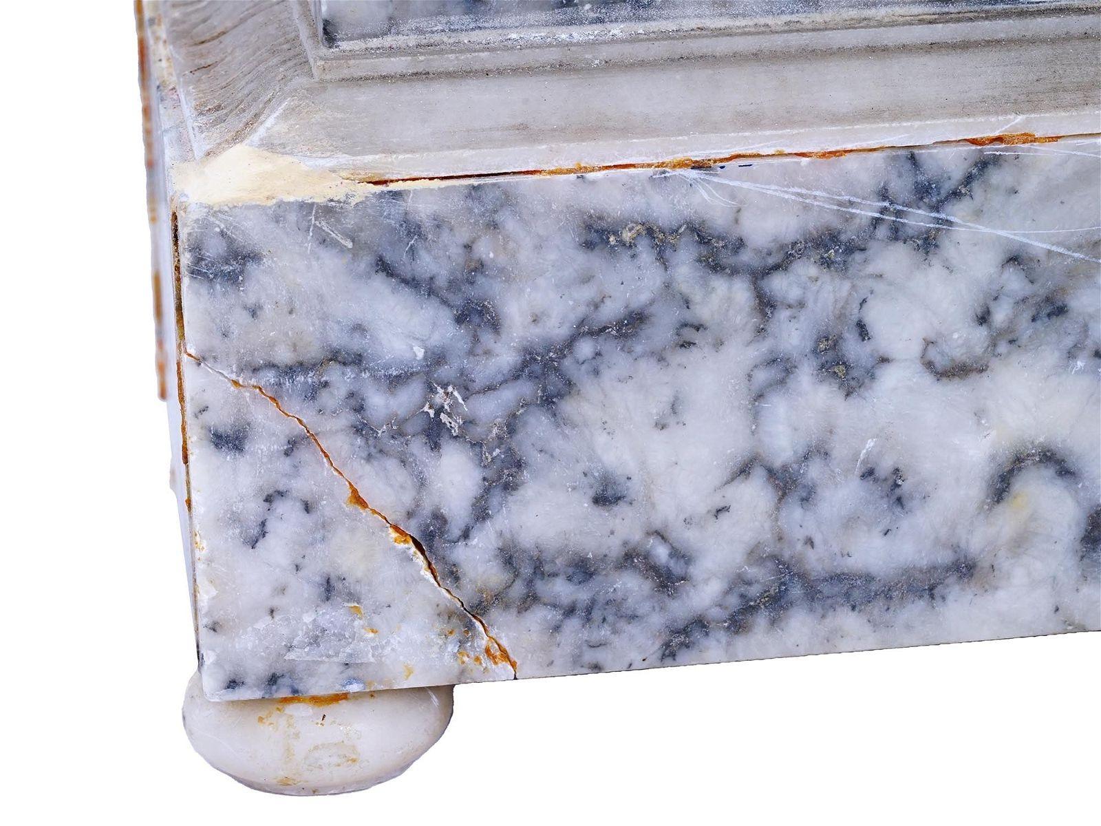 Antique mantel clock in the French Empire style with variegated white and charcoal marble case with hand-craved white marble neoclassical appliques including lyre, leafy branches and rosettes.  