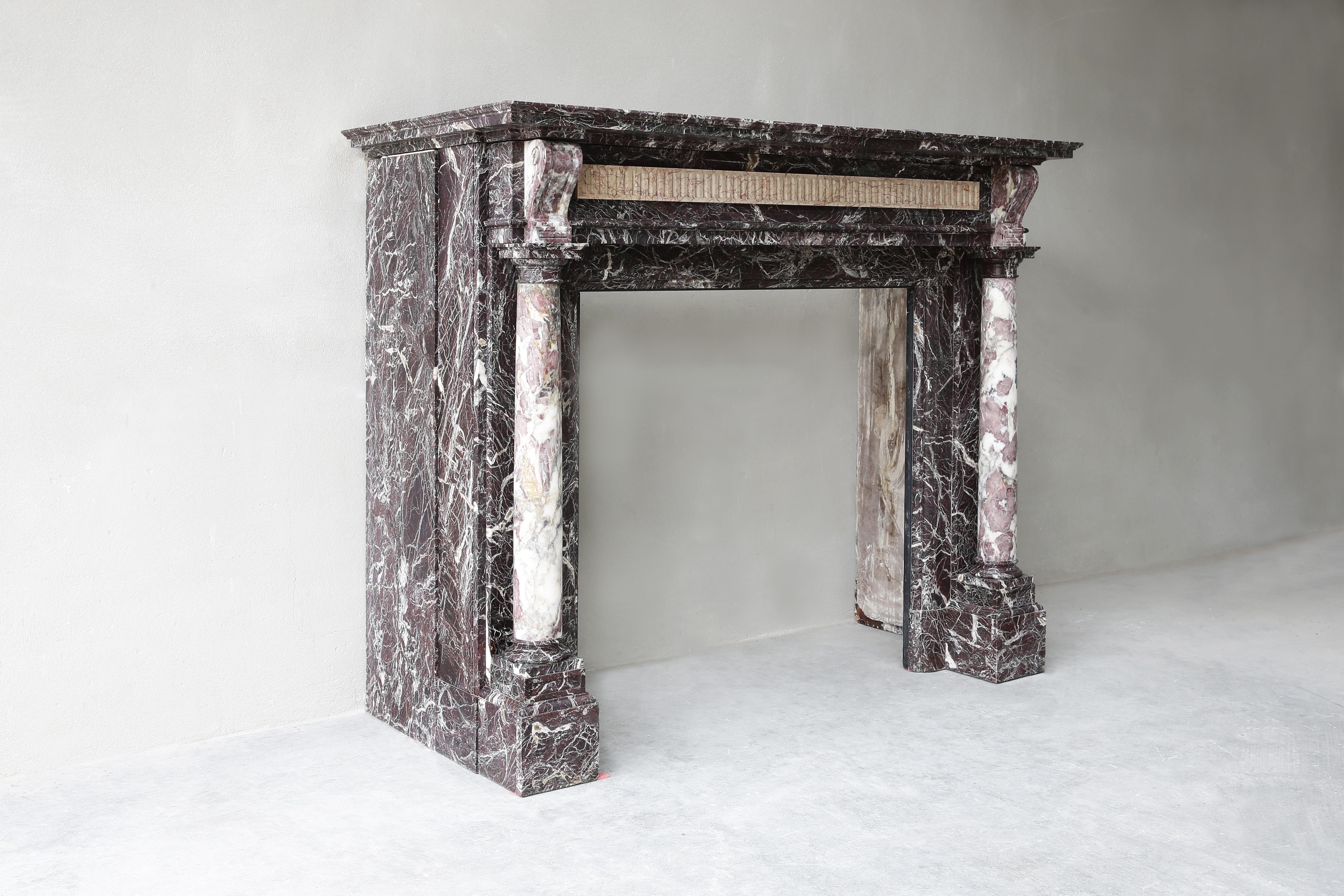 Exclusive antique marble fireplace with 19th century pillars! A beautiful mantle in our collection, with beautiful lines and ornaments, in the style of Louis XVI. The marble type is Levanto marble and is originally from Italy. We have taken this