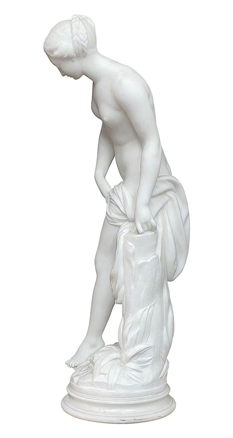 An enchanting 19th Century Italian Carrera marble statue of female nude bathing, pointing her toe in the water whilst learning against a tree stump.
 
Batch 73