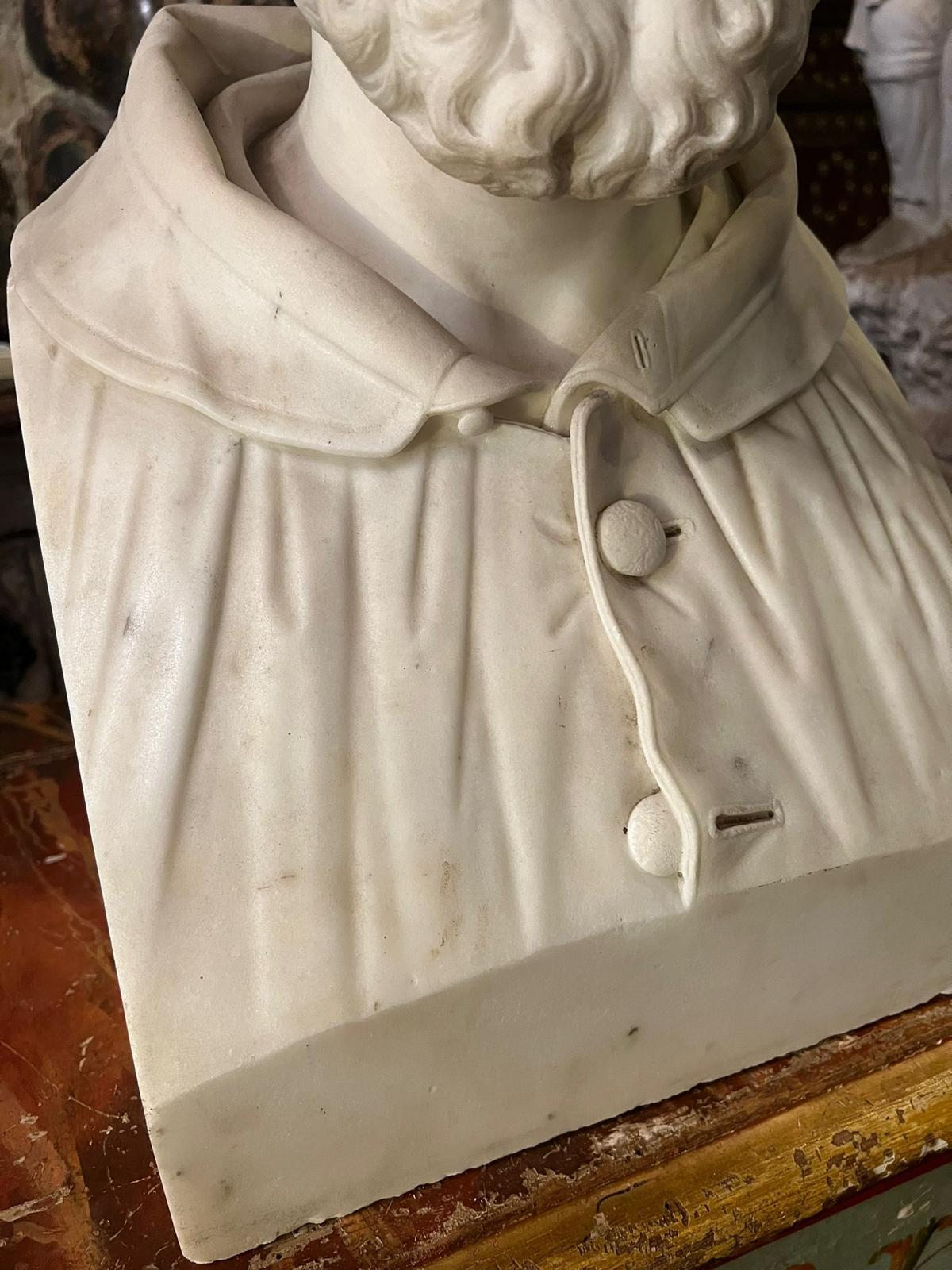Beautiful marble sculpture depicting a male figure. The bust depicts a young bearded man dressed in a tunic and hood, Giovanni Seleroni (1807 - 1894).