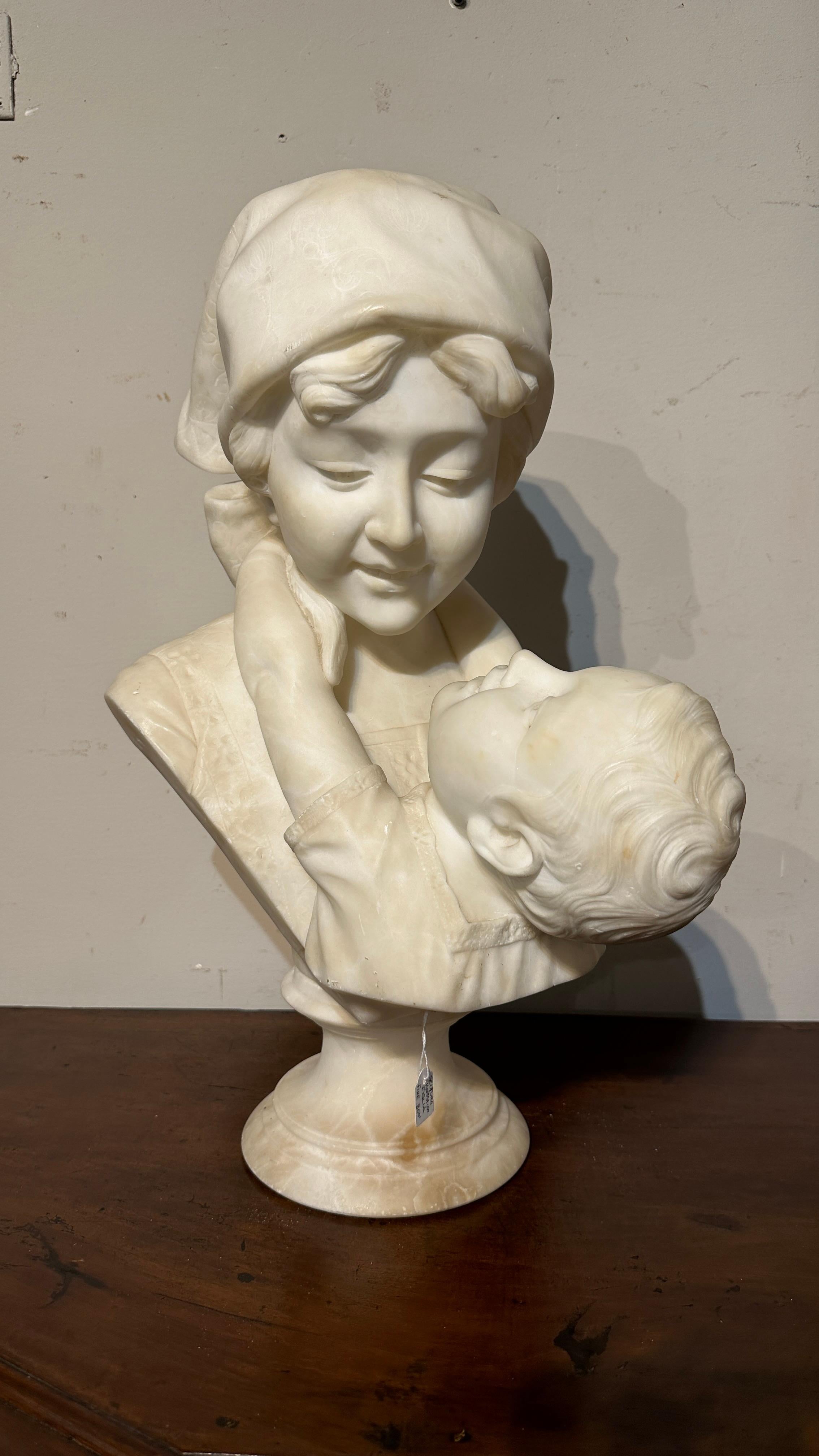 Coming from a Tuscan farmhouse, this enchanting marble sculpture is a valuable testimony to the typical Tuscan manufacturing of the mid-19th century. Hand-sculpted with skill, depicting the embrace of a son to his mother, transmitting the intensity