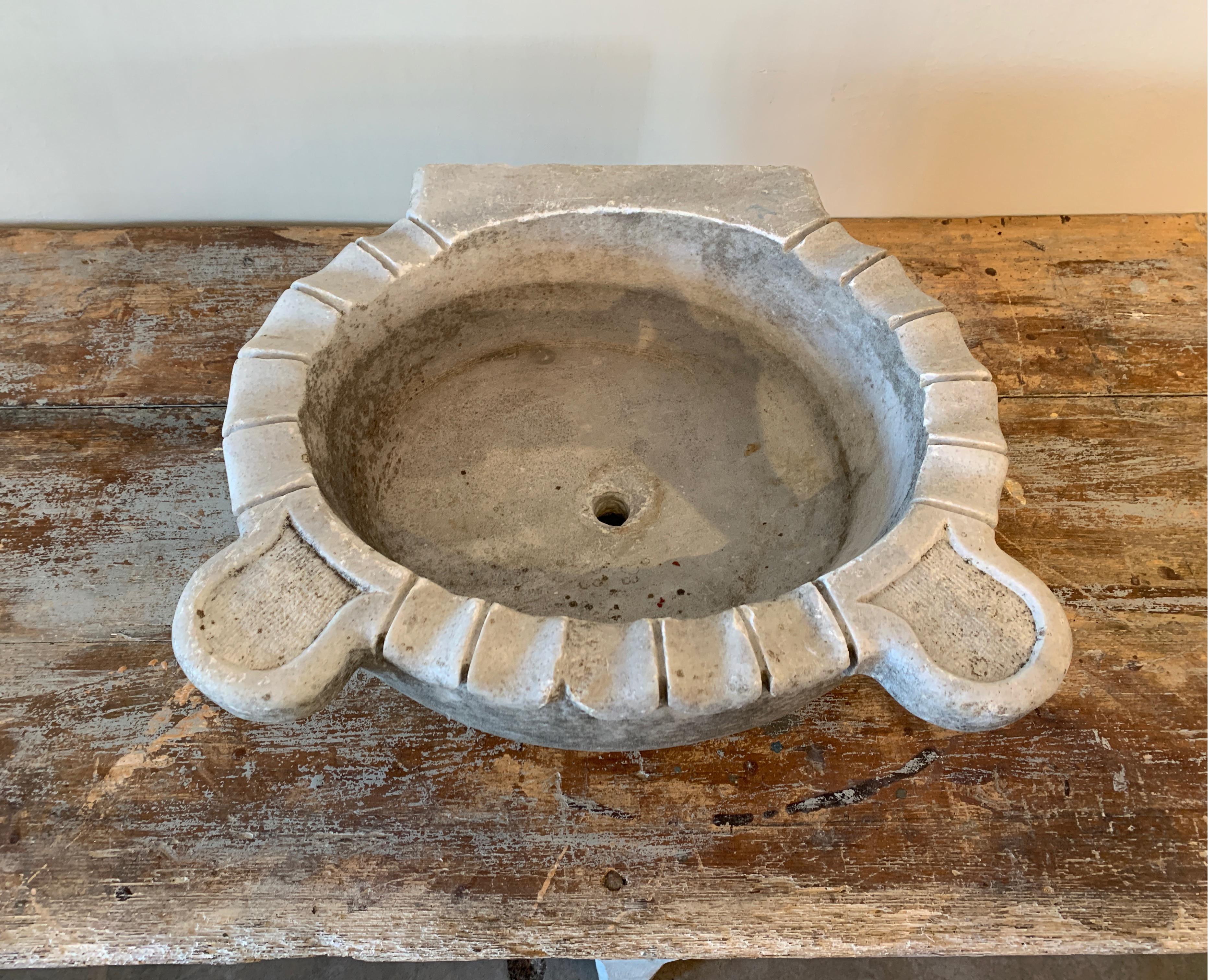 These stone sinks have been used in Turkish bath houses and homes for centuries.

This is a nice gray stone one with wonderful details throughout.