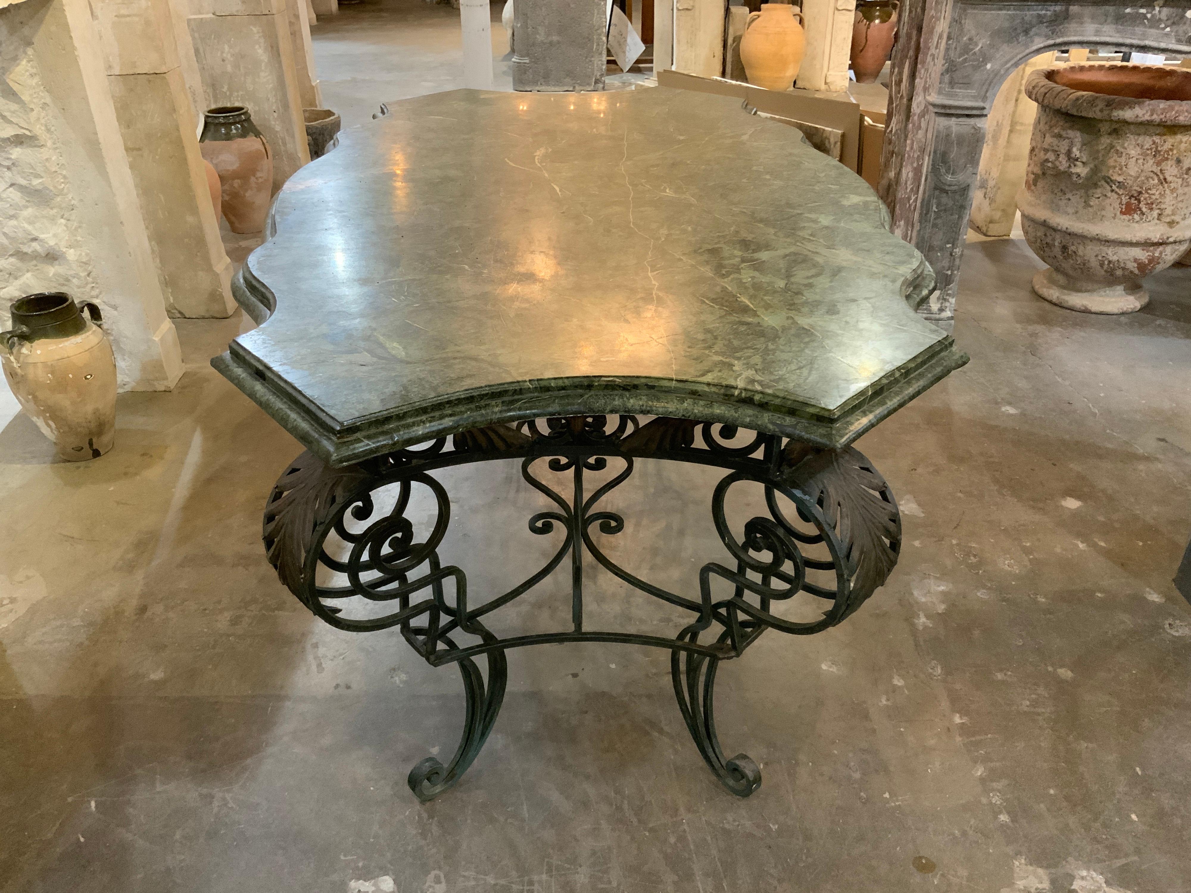 This marble table with iron base originates from France, circa 1880.