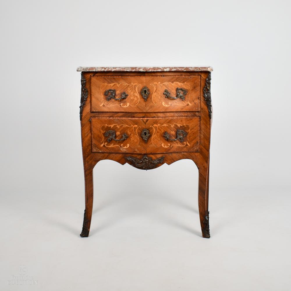 Marble top two drawer French Commode 19th Century in Kingwood and satinwood with inlaid panels of flowers in fruitwood. Two drawer, curved bombe front with four legs with gilt bronze ormolu mounts. Gilt bronze ormolu handles and further mounts on