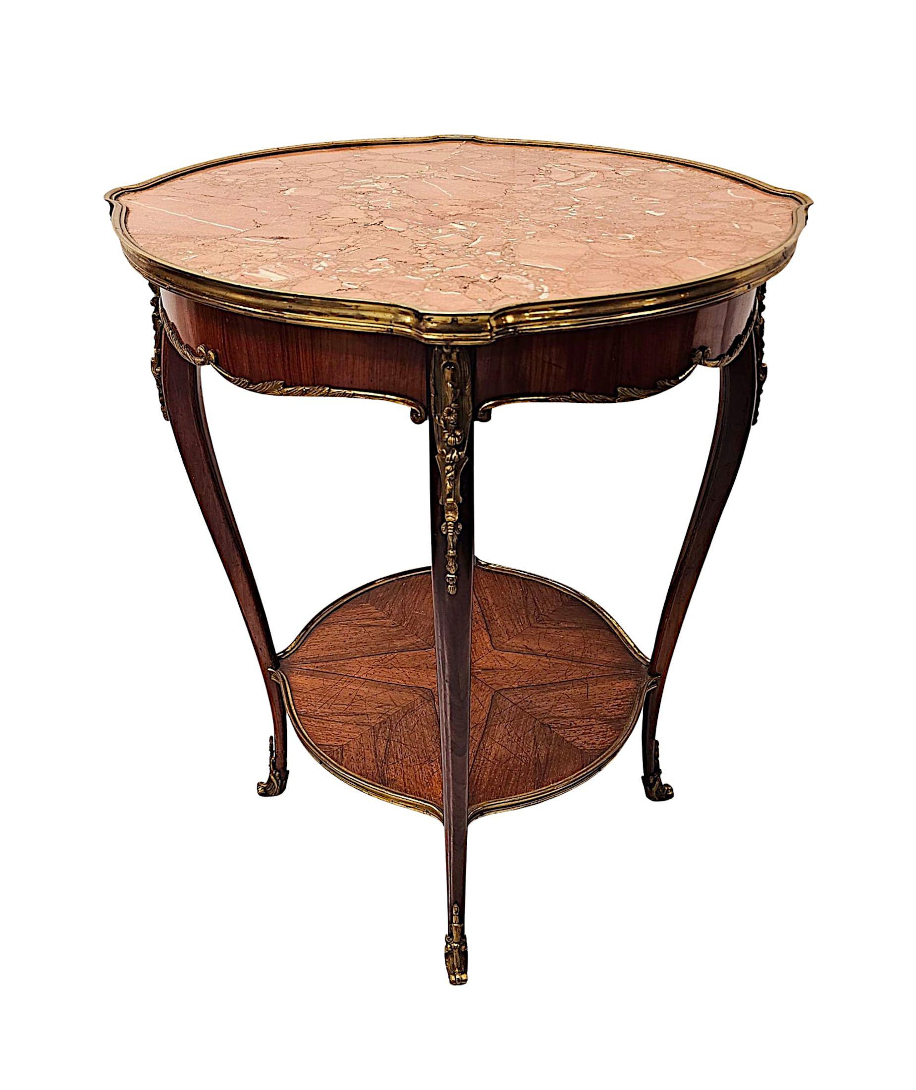 A stunning 19th Century well figured rosewood marble top occasional or lamp table of exceptional quality, finely hand carved with rich patination, fine grain and fitted with well cast ormolu mounts throughout.  The striking moulded Rosso Levante