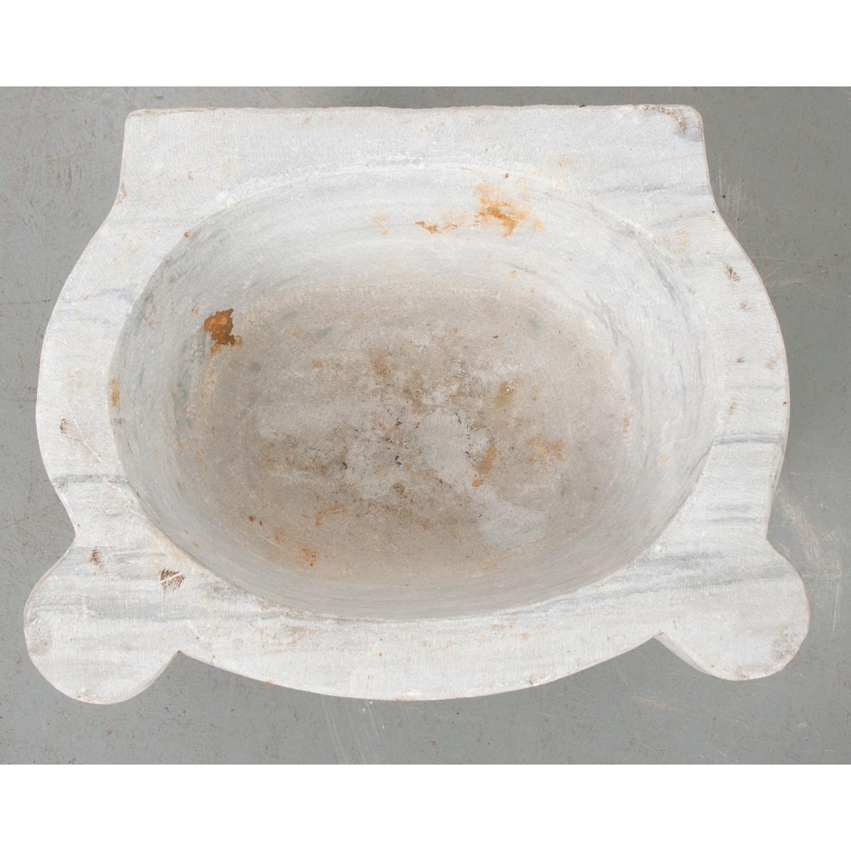 This is a European water basin with very thick walls. It is made of white marble with gray veins. This basin could easily be used as a basin for your bathroom, adding antique style and an appreciation for solid materials. 
 