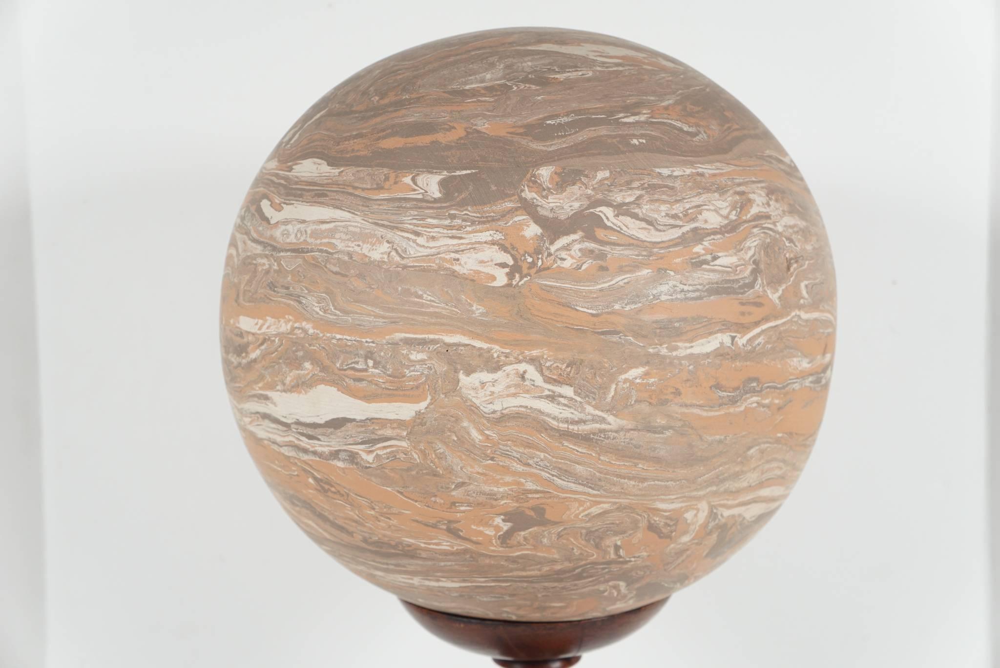 This Italian marbled terra cotta ball comes from Oak Springs Farm, the Virginia estate of Paul & Bunny Mellon. The sphere is late 19th century and has been set on a well-turned walnut stand. Made as purely a decorative object the sphere is very
