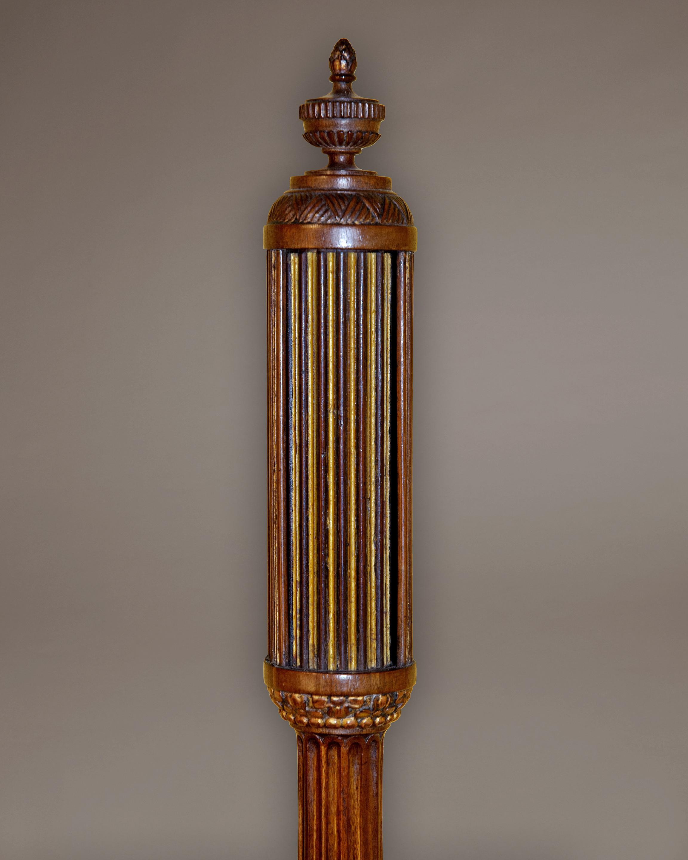 An early 19th century mahogany marine barometer of exceptional quality and originality. The elegant carved, fluted and turned case has an inset engraved bone register plate reading from 27 to 31 inches which shows the usual states of the weather