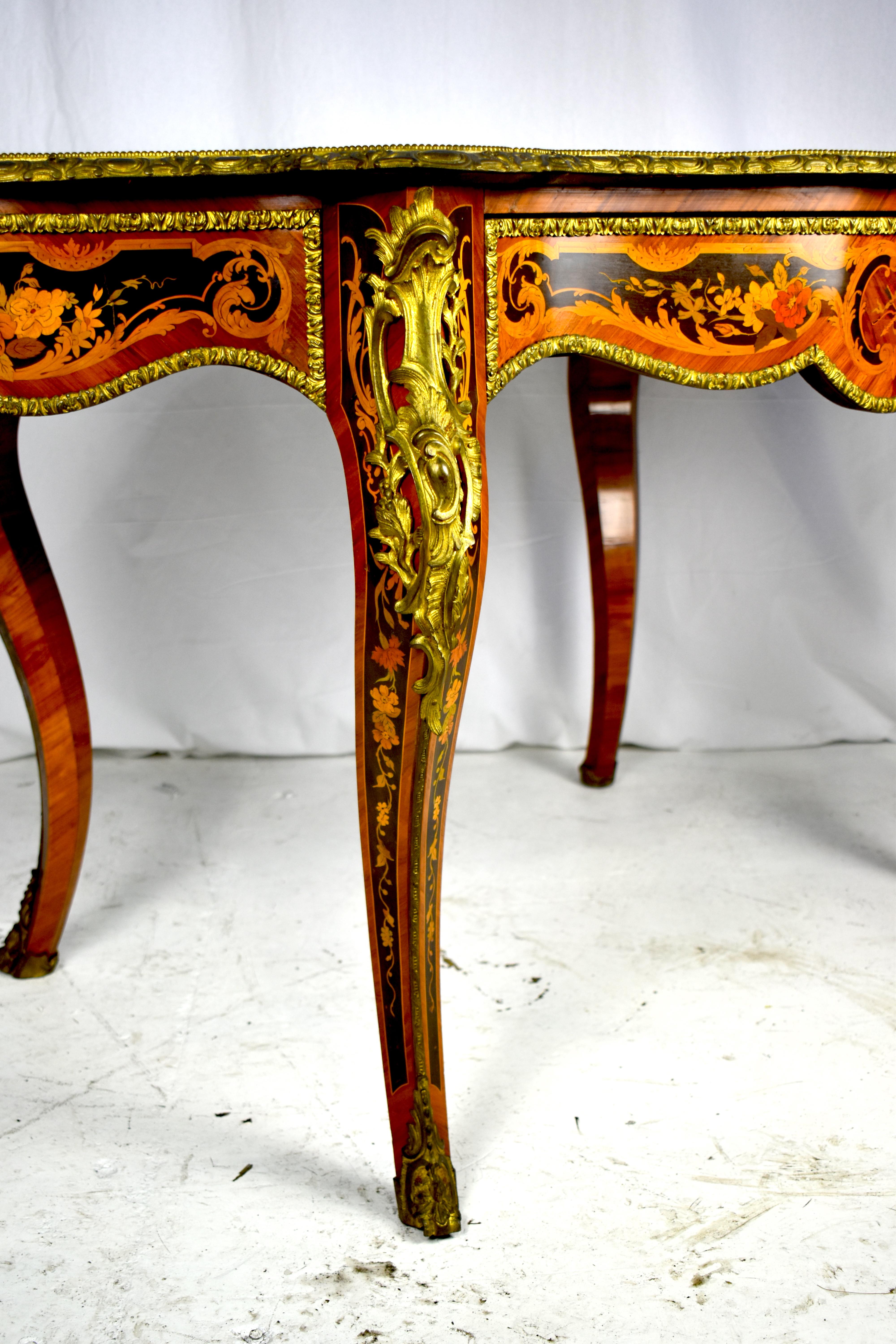 A very good quality French 19th century Louis XV style marquetry inlaid centre table. Having wonderful scrolling and foliate decoration to the top and sides, ormolu mounts, a single frieze drawer and raised on elegant cabriole legs.
 