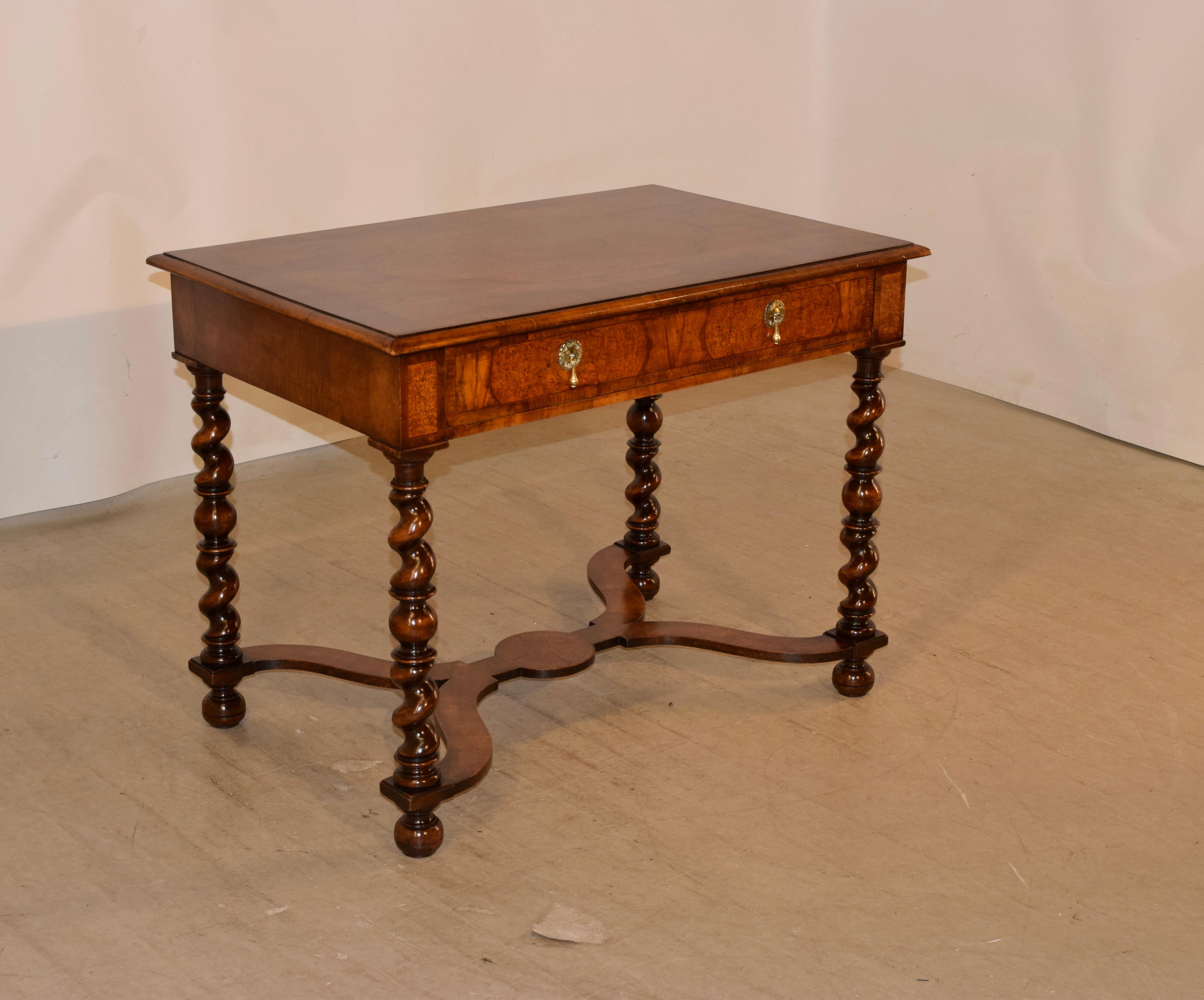 19th century William and Mary style burl walnut table with exquisite marquetry detailing. The top is banded and has a beveled edge surrounding a profuse floral marquetry pen and ink work detailed top, following down to a single drawer in the front