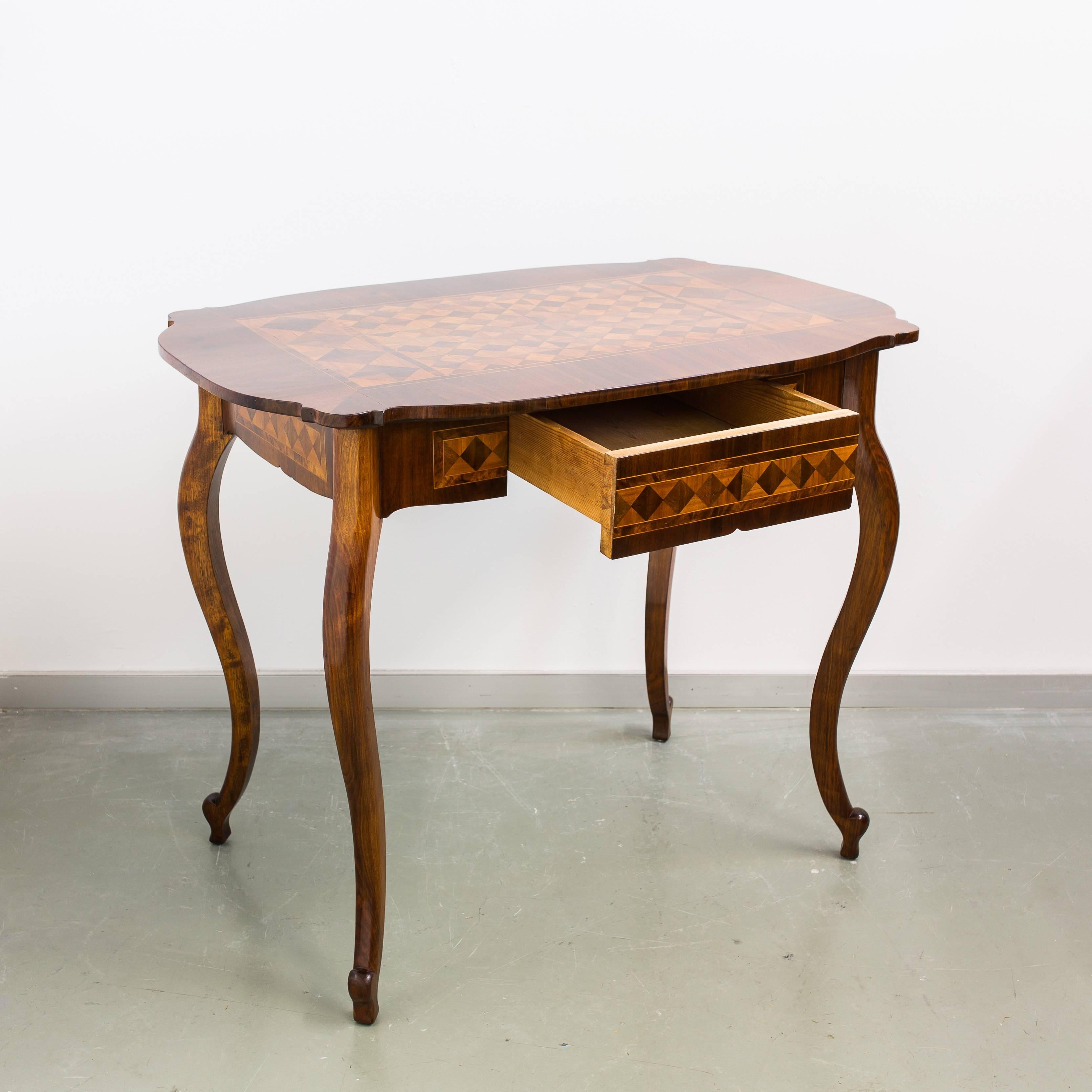 Lovely shaped 19th century Marquetry table with drawer from the Baroque Revival period in Austria, circa 1850. Slender legs made of solid walnut wood, a wonderful marquetry work on the tabletop and each side framed by thin maple threads, makes this