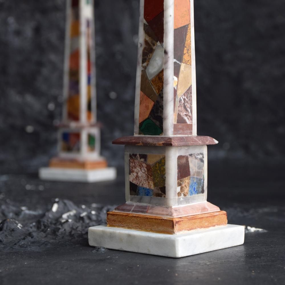 19th century matching pair of grand tour marble specimen obelisks We are proud to offer a wonderful example of matching grand tour marble specimen obelisks containing many rare samples stones including malachite, Lazulite and inlaid on all 4 sides