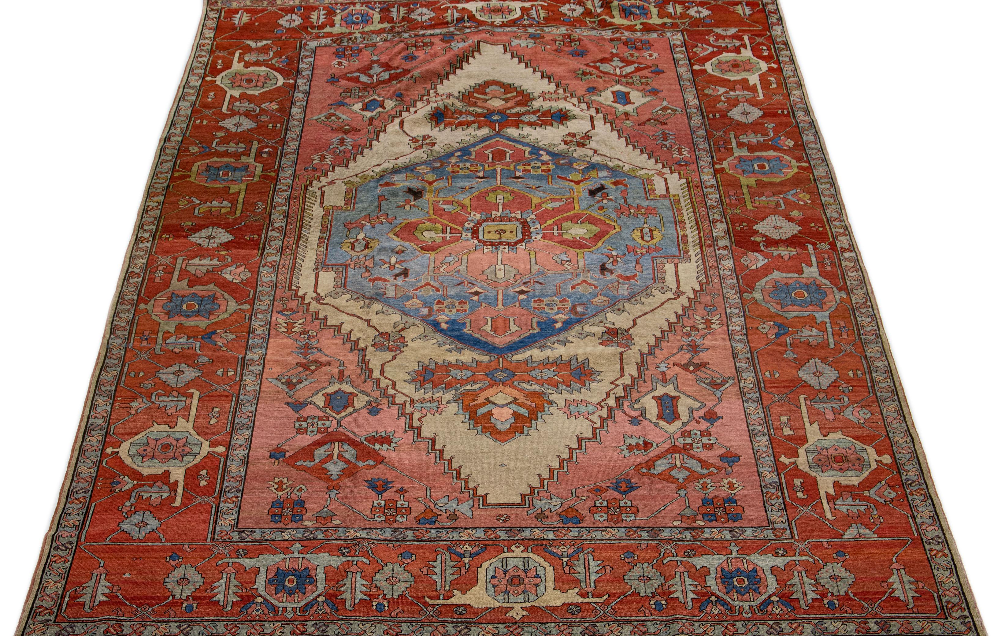 This elegant wool rug features a stunning medallion floral design with a beige and rust color field. Its antique Serapi-style is complemented by a rusted-designed frame and subtle multicolor accents, making it a truly gorgeous piece.

This rug