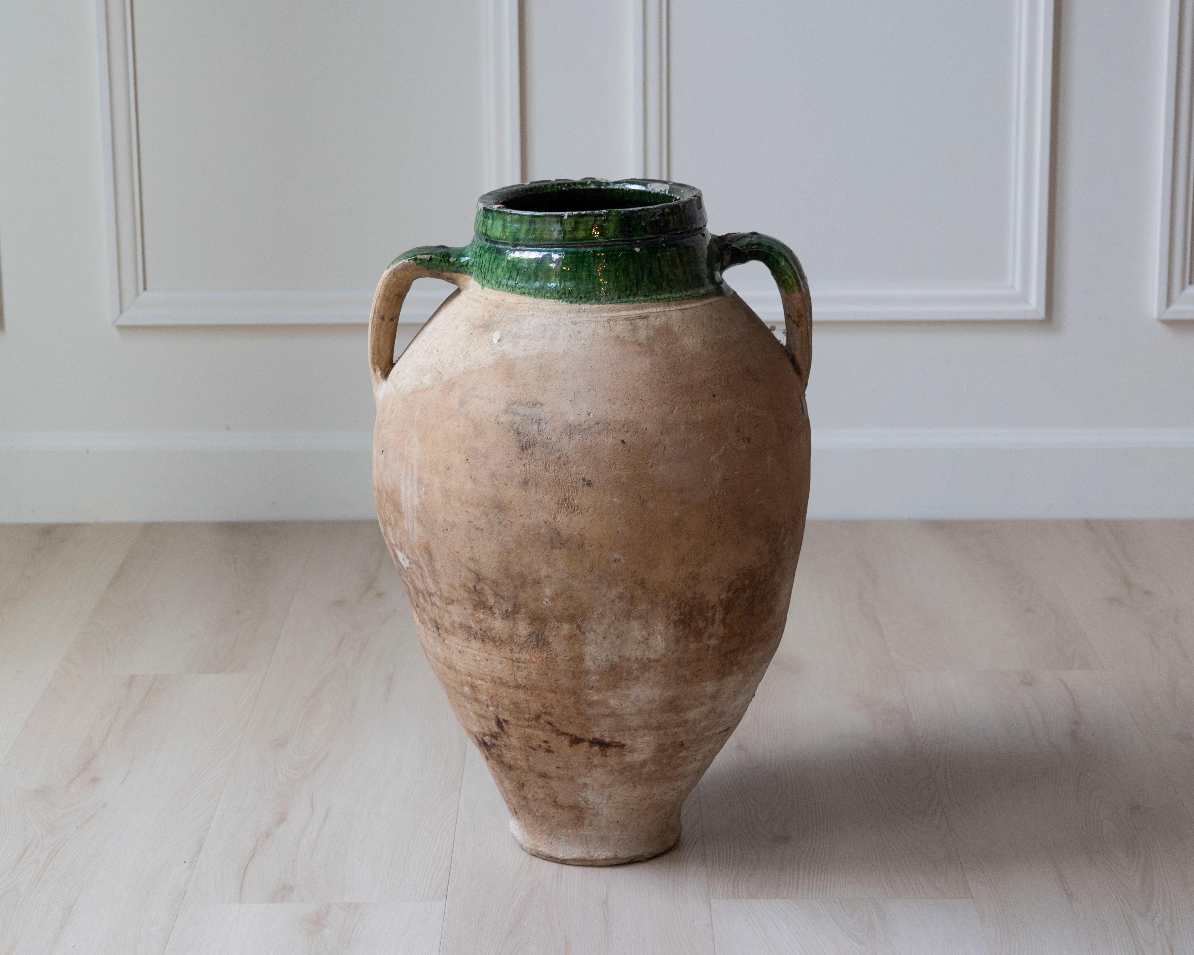 This Mediterranean terracotta jar, dating to the 19th century, is a beautiful example of utilitarian pottery elevated by form and patina. Likely originating from Southern Italy or the South of France, the jar features a classic ovoid silhouette with
