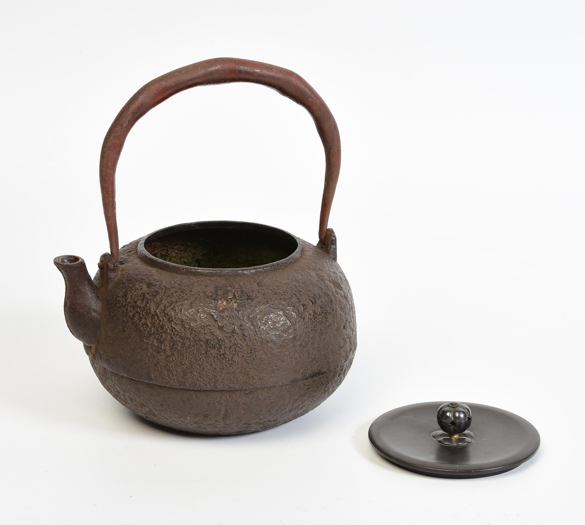 Antique Japanese iron teapot with bronze lid.

Age: Japan, Meiji Period, 19th Century
Size: Height 19.8 C.M. / Width 17.3 C.M. / Diameter 15.5
Condition: Nice condition overall. 

100% satisfaction and authenticity guaranteed with free 