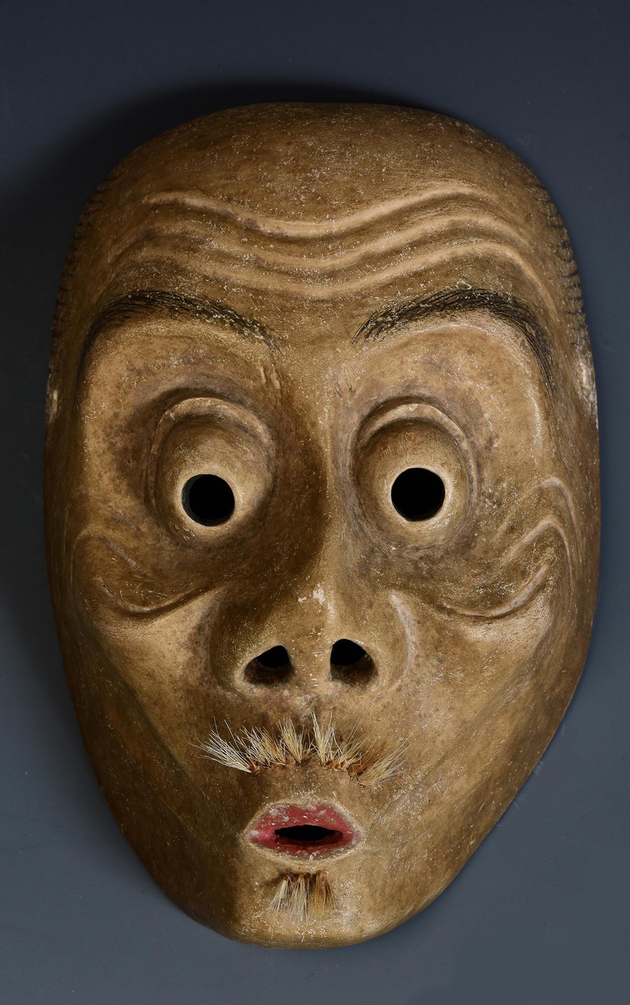 Antique Japanese wooden Noh mask.

Age: Japan, Meiji Period, 19th Century
Size: Length 20 C.M. / Width 13.9 C.M. / Thickness 8 C.M.
Condition: Nice condition overall (some expected degradation due to its age).

100% satisfaction and authenticity