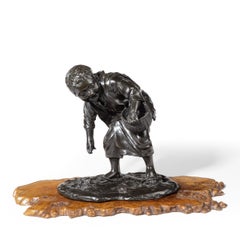 19th Century Meiji Period Bronze of a Boy Collecting Sweet Chestnuts by Seiya