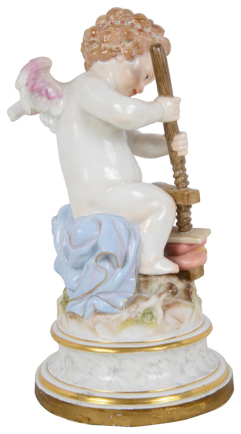 An enchanting late 19th Century Meissen Porcelain cherub, press two hearts together. Wonderful bold colours, blue underglaze blue crossed swords to the base.