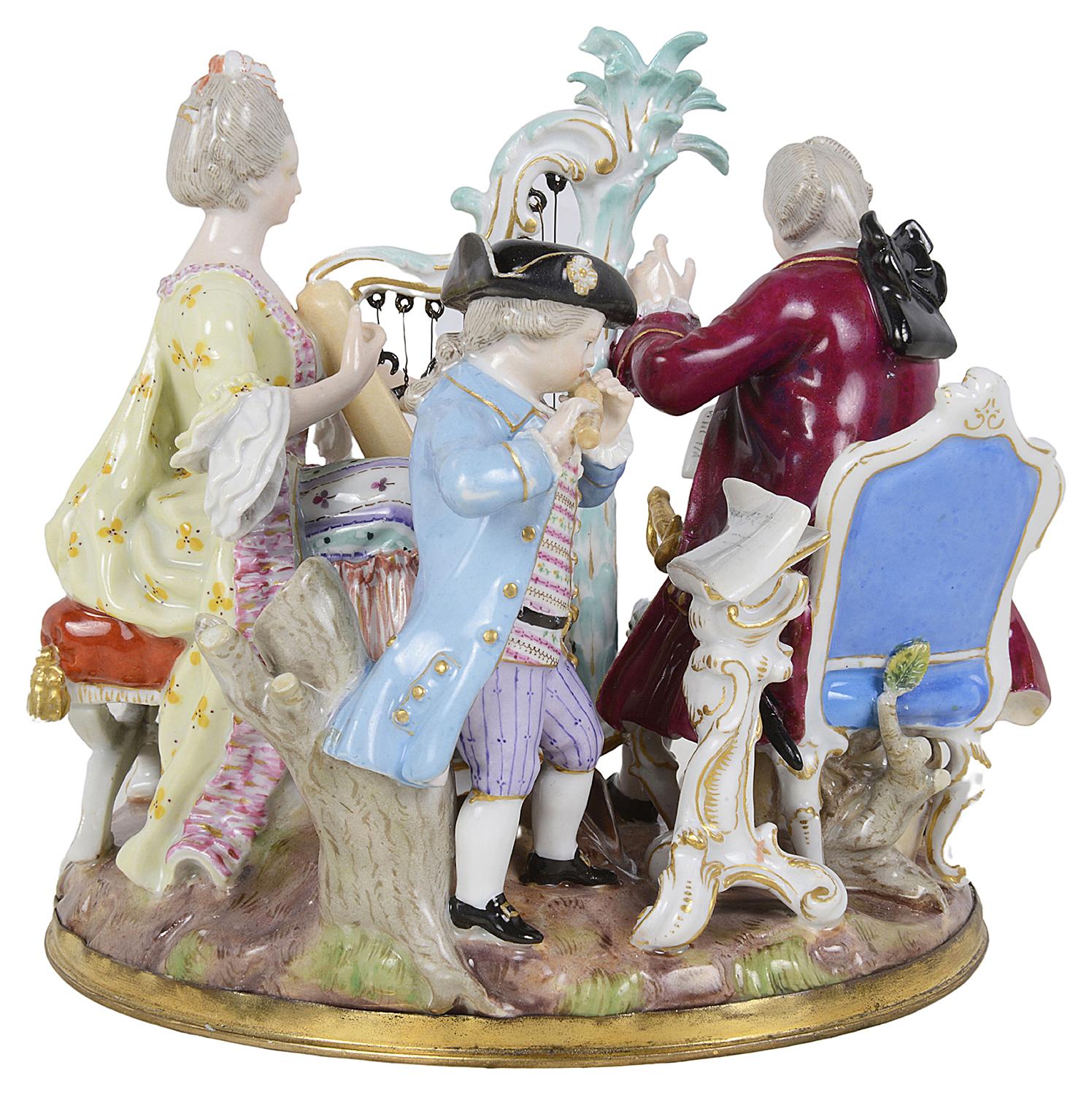 A charming 19th century Meissen Porcelain figurine group of three musicians, two seated, playing a Harp and flute, the gentleman holding the music.
Wonderful bold colours, underglaze blue cross swords to the base.