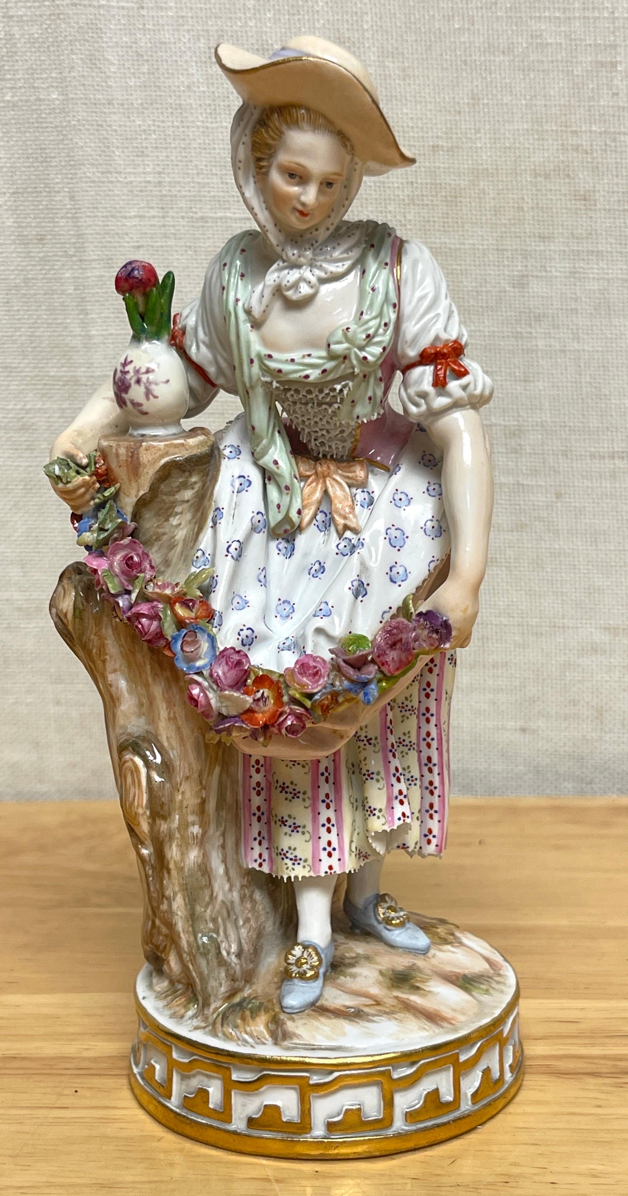 19th Century Meissen figurine of a lady gardener
Germany, Circa 1890s.

19th-century Meissen figurine depicting a lady gardener, crafted in Germany circa the 1890s. This exquisite porcelain piece captures the elegance of the period with a standing
