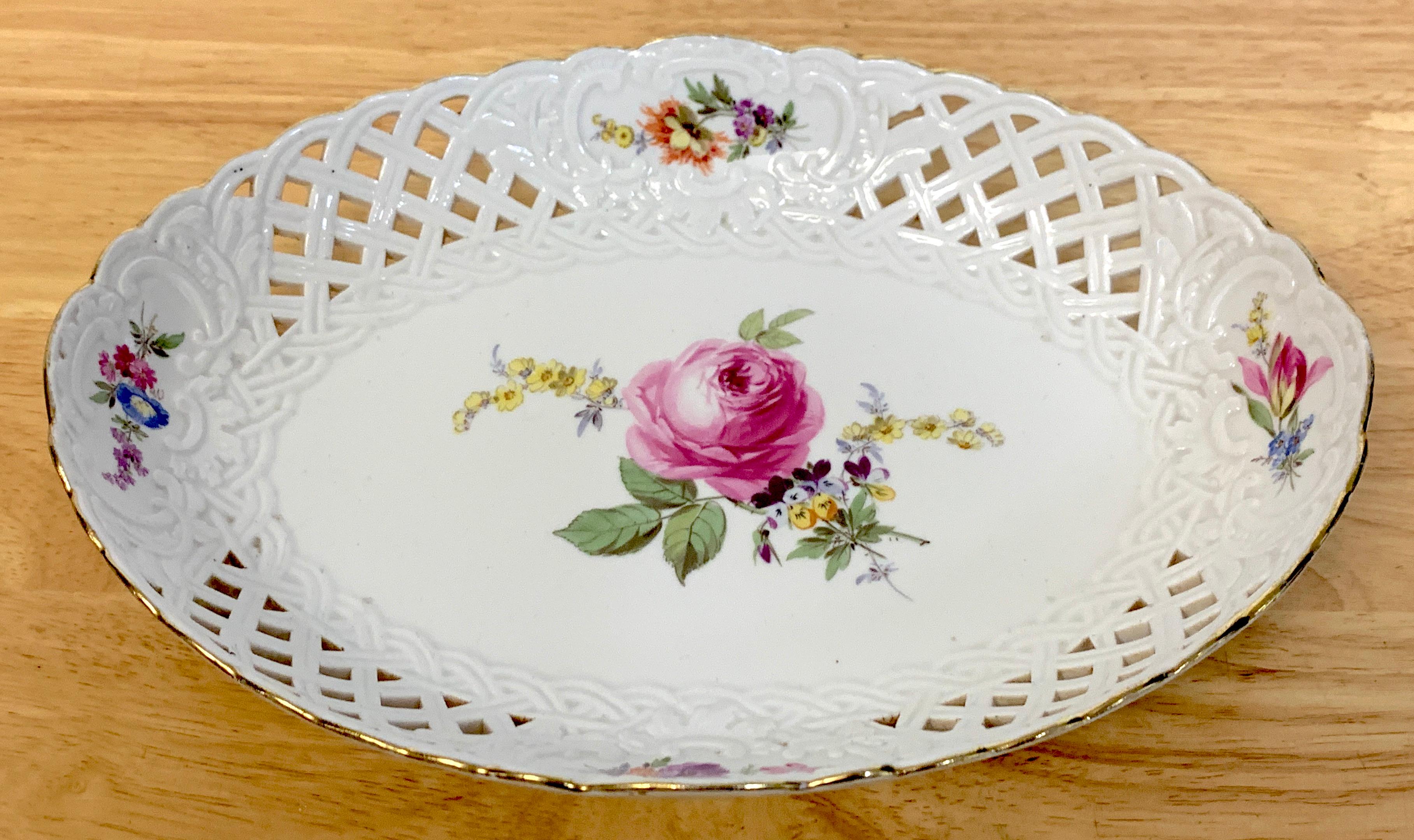 19th century Meissen floral painted reticulated oval basket, with gilt rim, pierced surround, hand painted with center rose bouquet, floral sprays, inside and out.
      