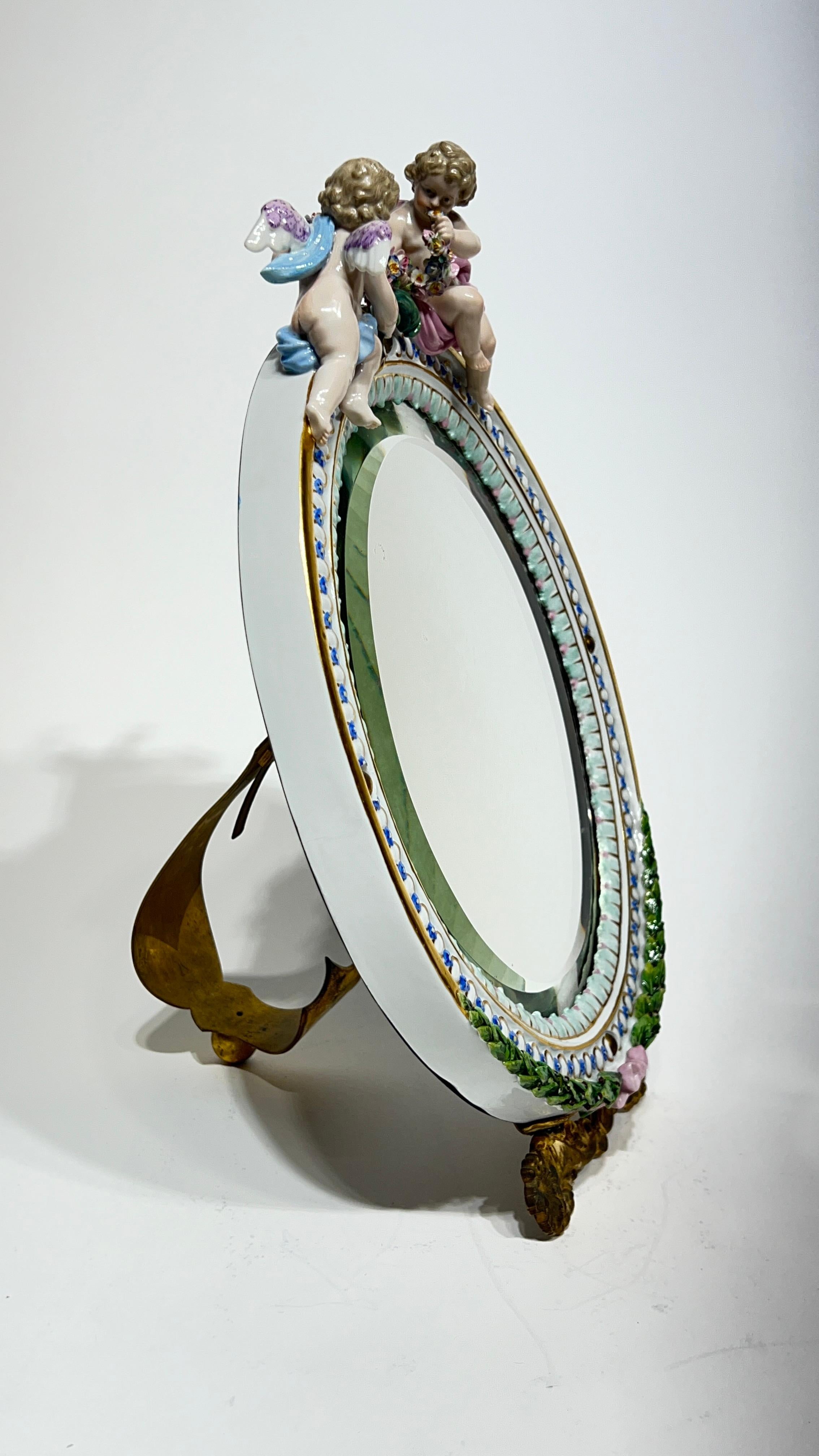Beautiful tabletop boudoir mirror from Meissen with gilt bronze stand and incised backplate and stand.  Excellent condition with only light scratches and a few small areas of silvering loss, and no apparent losses to the porcelain.
