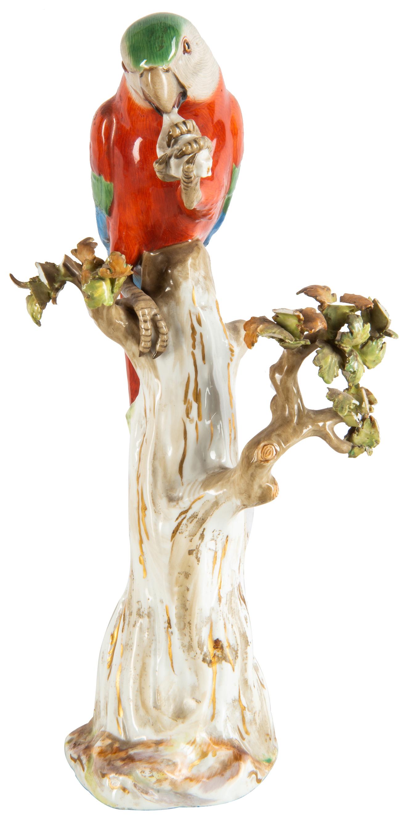 A good quality late 19th century Meissen porcelain parrot perched on a tree stump feeding.
Blue crossed swords to base.