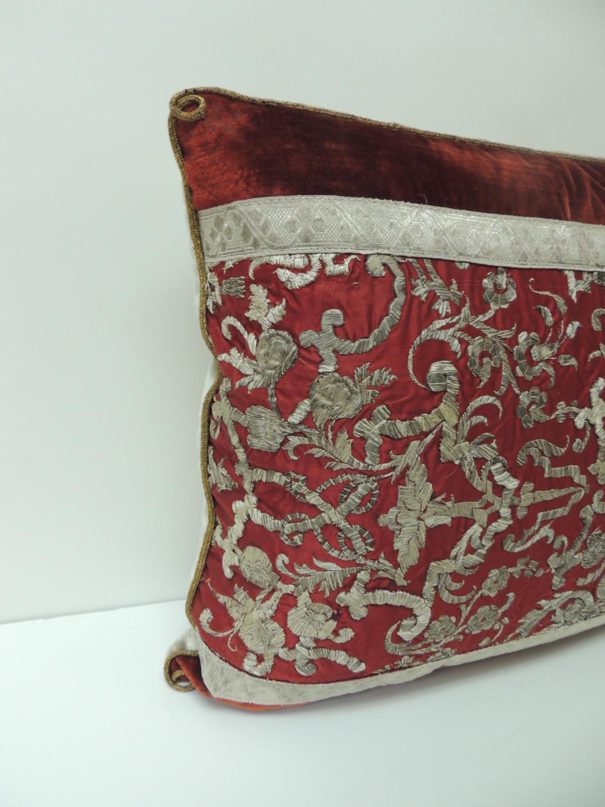 Decorative pillow handcrafted with 19th century Italian metallic silver threads embroidered onto silk. Antique lumbar decorative pillow framed with red silk antique velvet and embellished with 19th century silver metallic flat trims. Accentuated