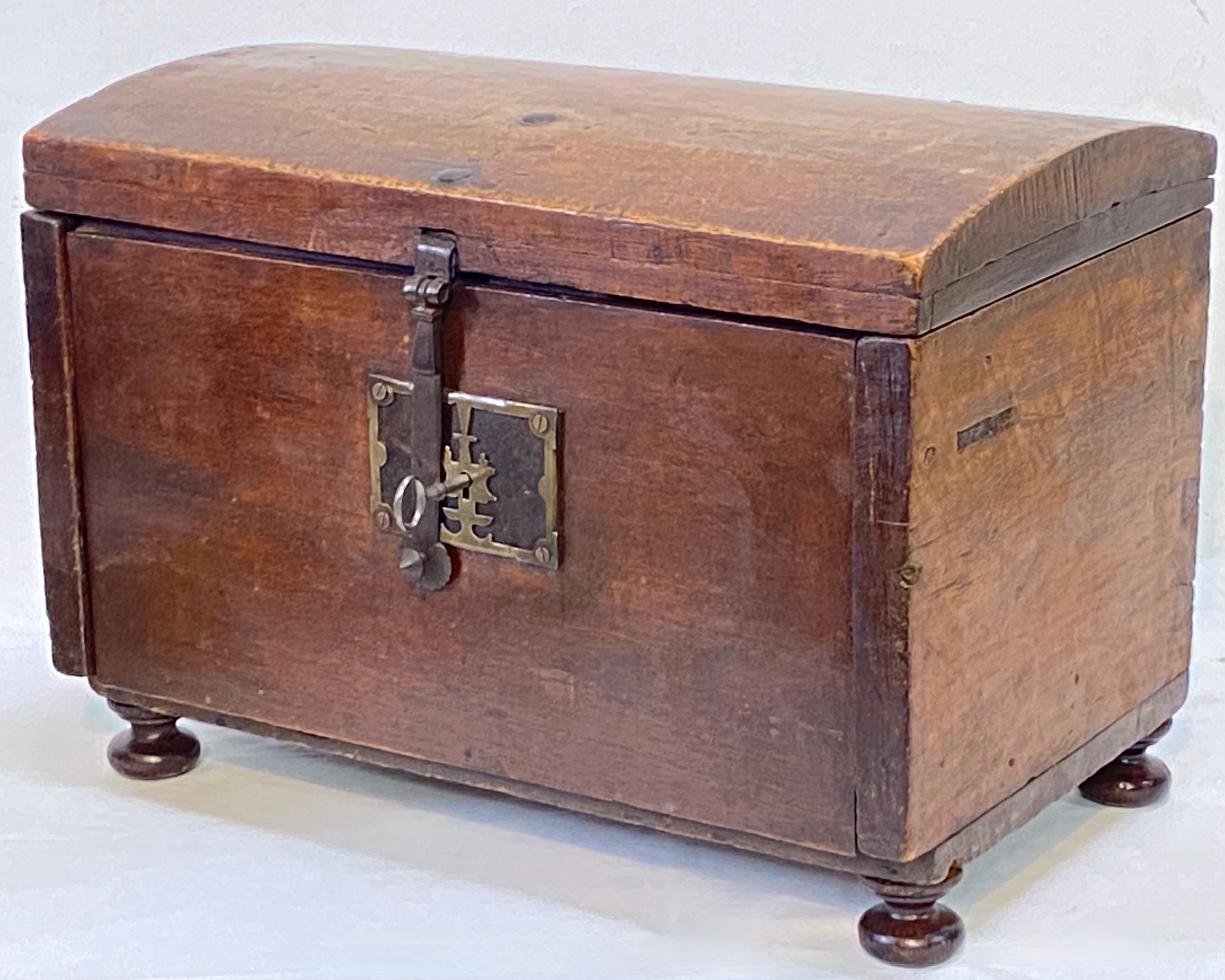 Carved hardwood (possibly walnut) storage box with fitted multi drawer interior.
Old stain and wax finish. Having a functional lock with key.
The pad feet are not original.
Wonderful antique condition with excellent character.
Mexico, 19th