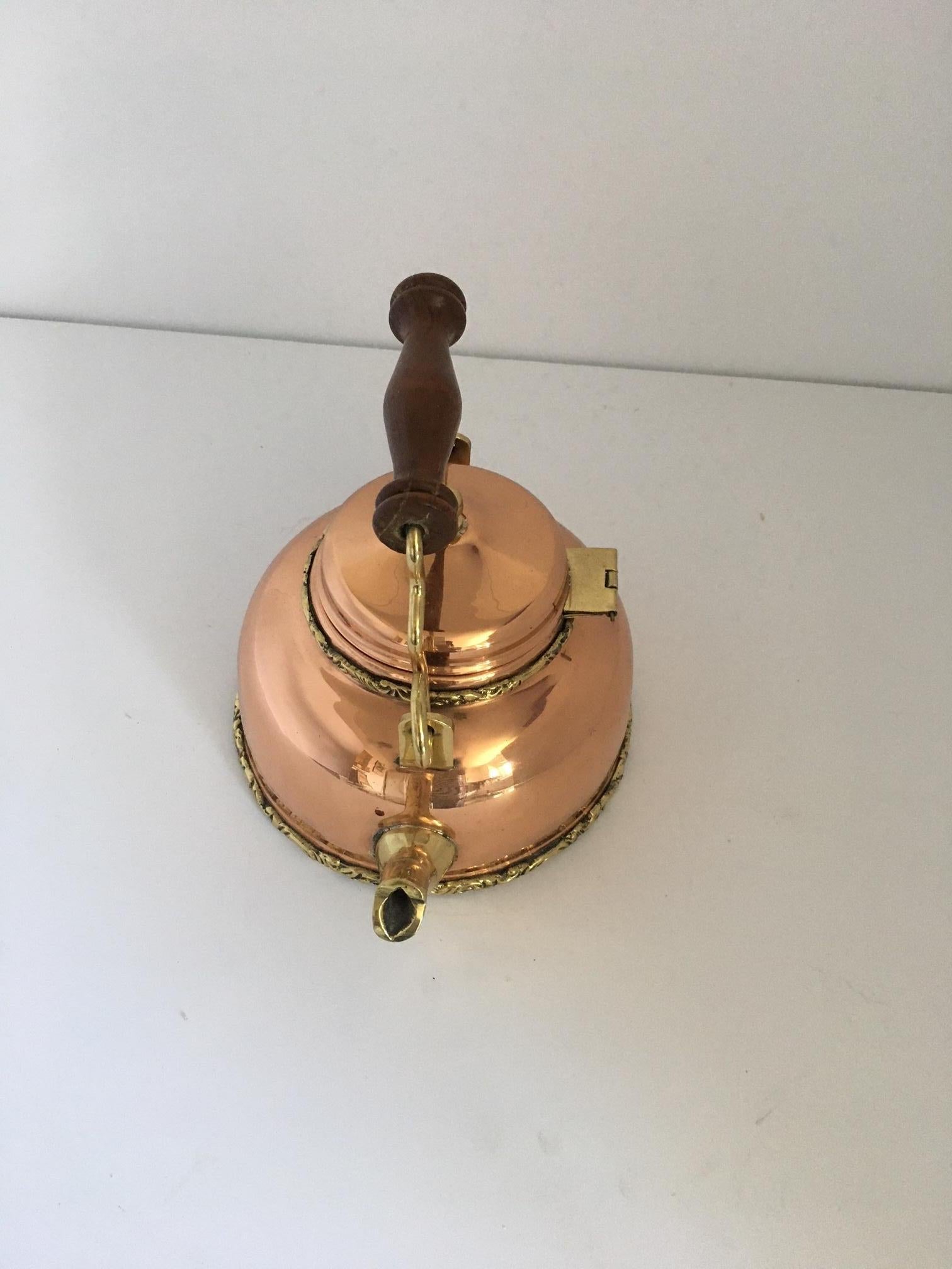 19th-century copper tea kettle with brass accents.
