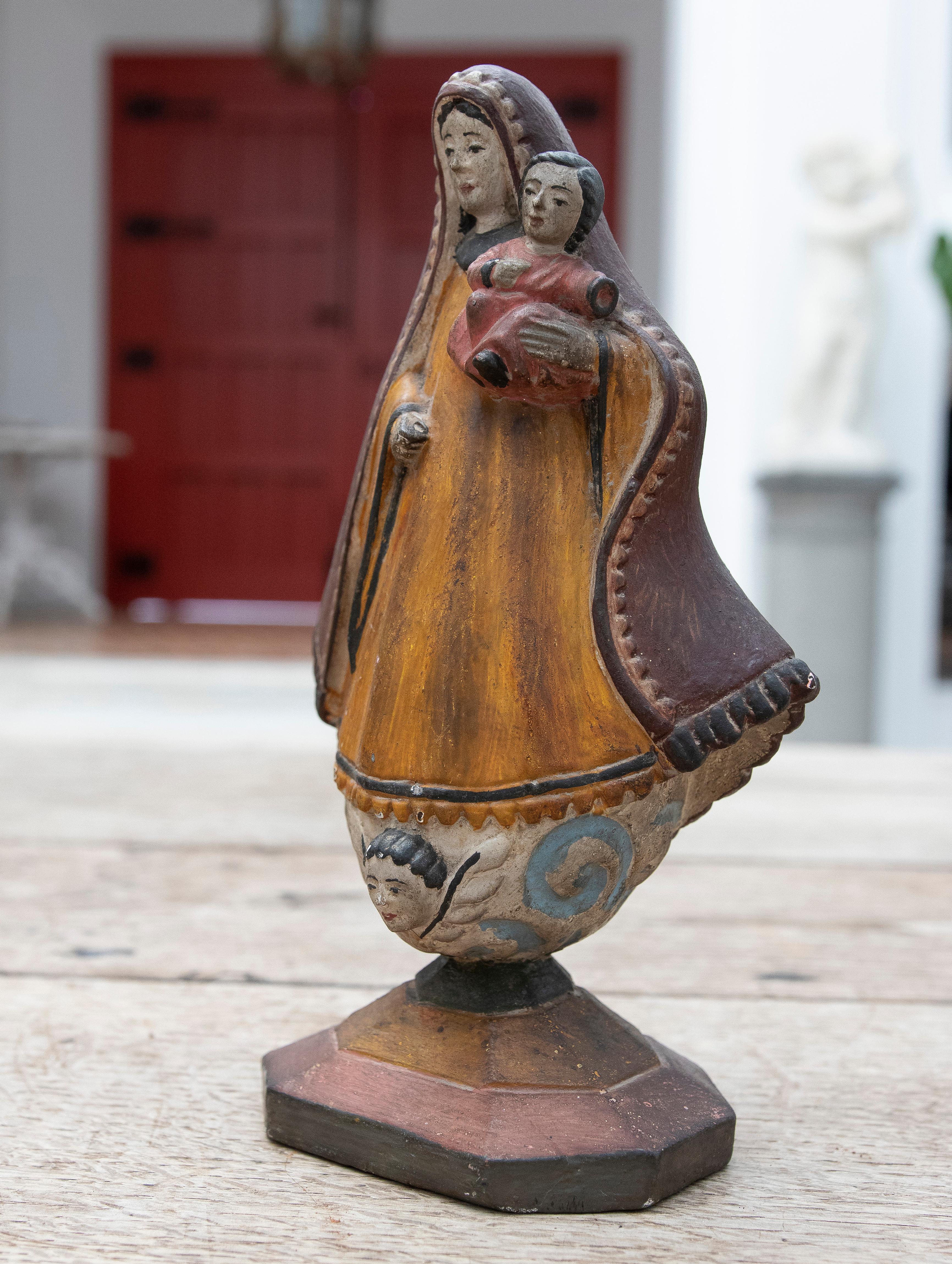 19th Century Mexican wooden hand-painted virgin with child in arms.